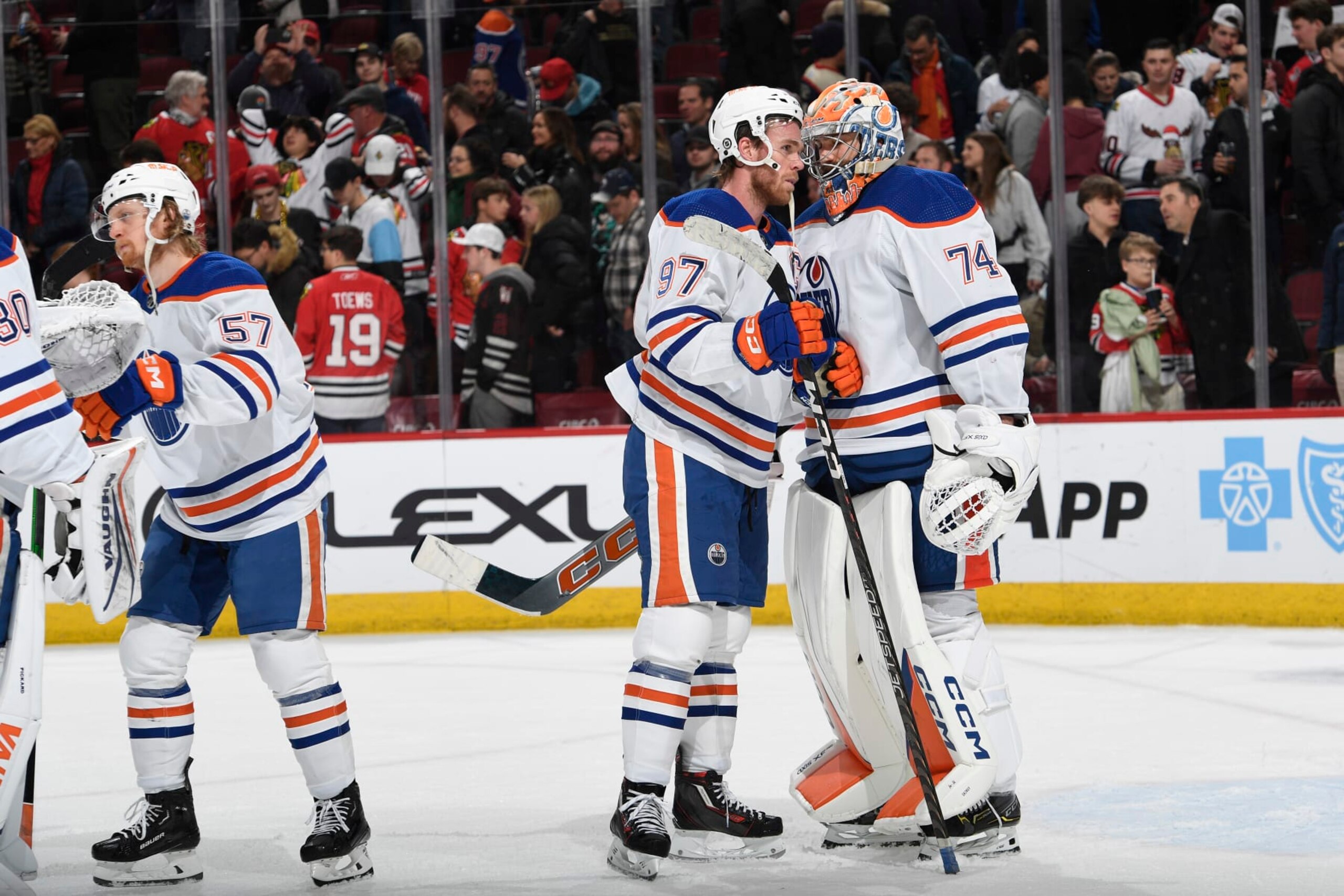 CHICAGO, ILLINOIS - JANUARY 09: Connor McDavid #97 of the Edmonton Oilers celebrates with teammate goalie Stuart Skinner #74 after defeating the Chicago Blackhawks 2-1 at the United Center on January 09, 2024 in Chicago, Illinois. (Photo by Bill Smith/NHLI via Getty Images) CHICAGO, ILLINOIS - JANUARY 09: Connor McDavid #97 of the Edmonton Oilers celebrates with teammate goalie Stuart Skinner #74 after defeating the Chicago Blackhawks 2-1 at the United Center on January 09, 2024 in Chicago, Illinois. (Photo by Bill Smith/NHLI via Getty Images)