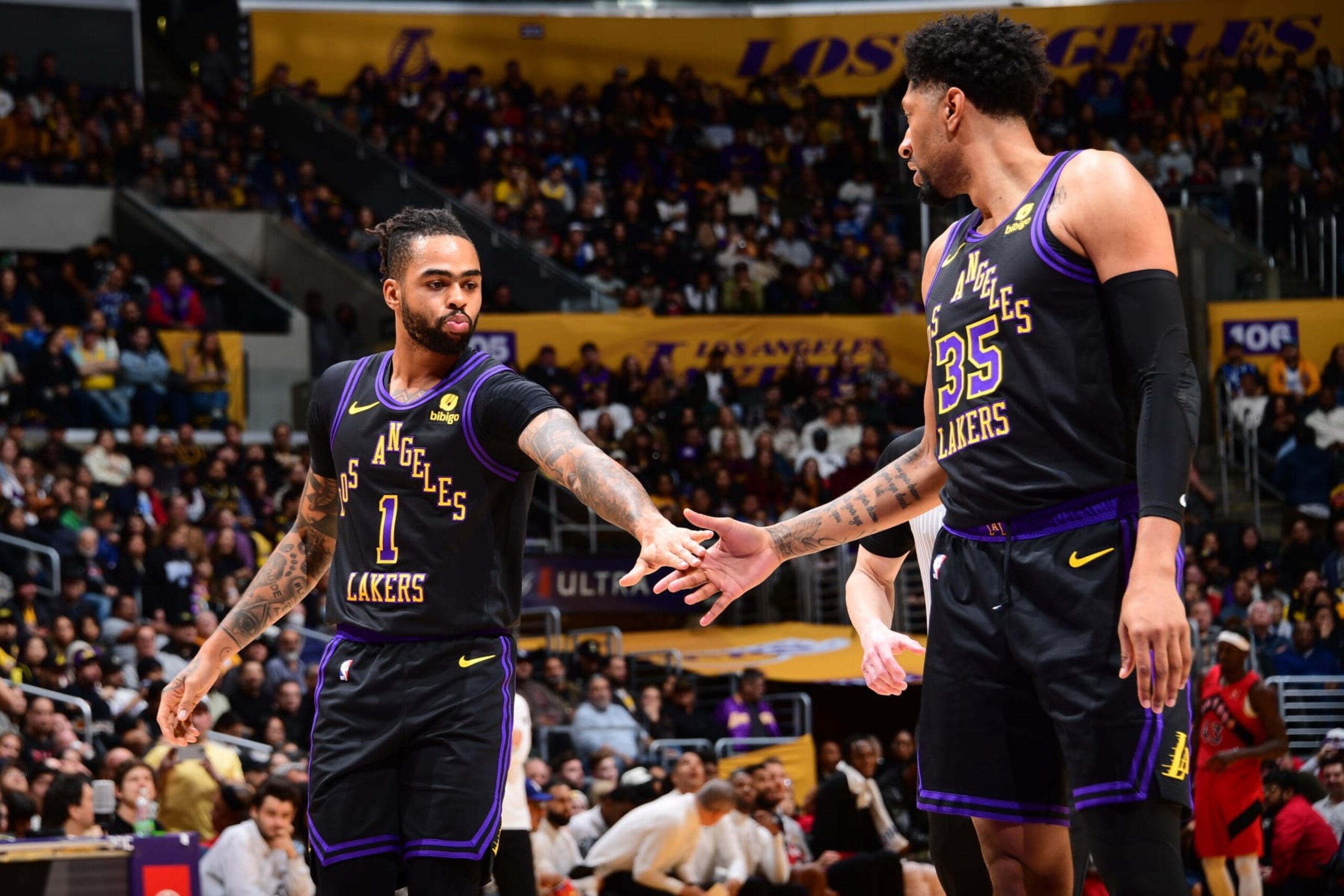 LOS ANGELES, CA - JANUARY 9: D'Angelo Russell #1 high fives Christian Wood #35 of the Los Angeles Lakers during the game against the Toronto Raptors on January 9, 2024 at Crypto.Com Arena in Los Angeles, California. NOTE TO USER: User expressly acknowledges and agrees that, by downloading and/or using this Photograph, user is consenting to the terms and conditions of the Getty Images License Agreement. Mandatory Copyright Notice: Copyright 2024 NBAE (Photo by Adam Pantozzi/NBAE via Getty Images)