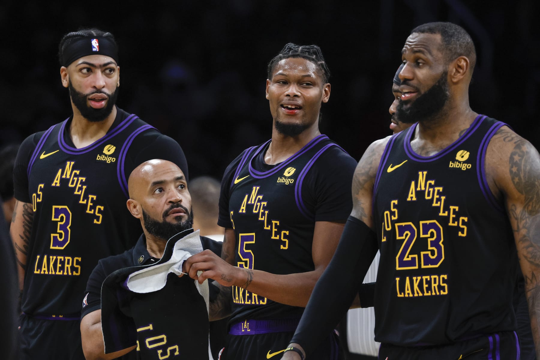 Los Angeles, CA, Tuesday, January 9, 2024 - Los Angeles Lakers forward Cam Reddish (5) is escorted by teammates after sustaining a bloody lip from the elbow of Toronto Raptors guard Immanuel Quickley (5) in the second half at Crypto.Com Arena. (Robert Gauthier/Los Angeles Times via Getty Images)