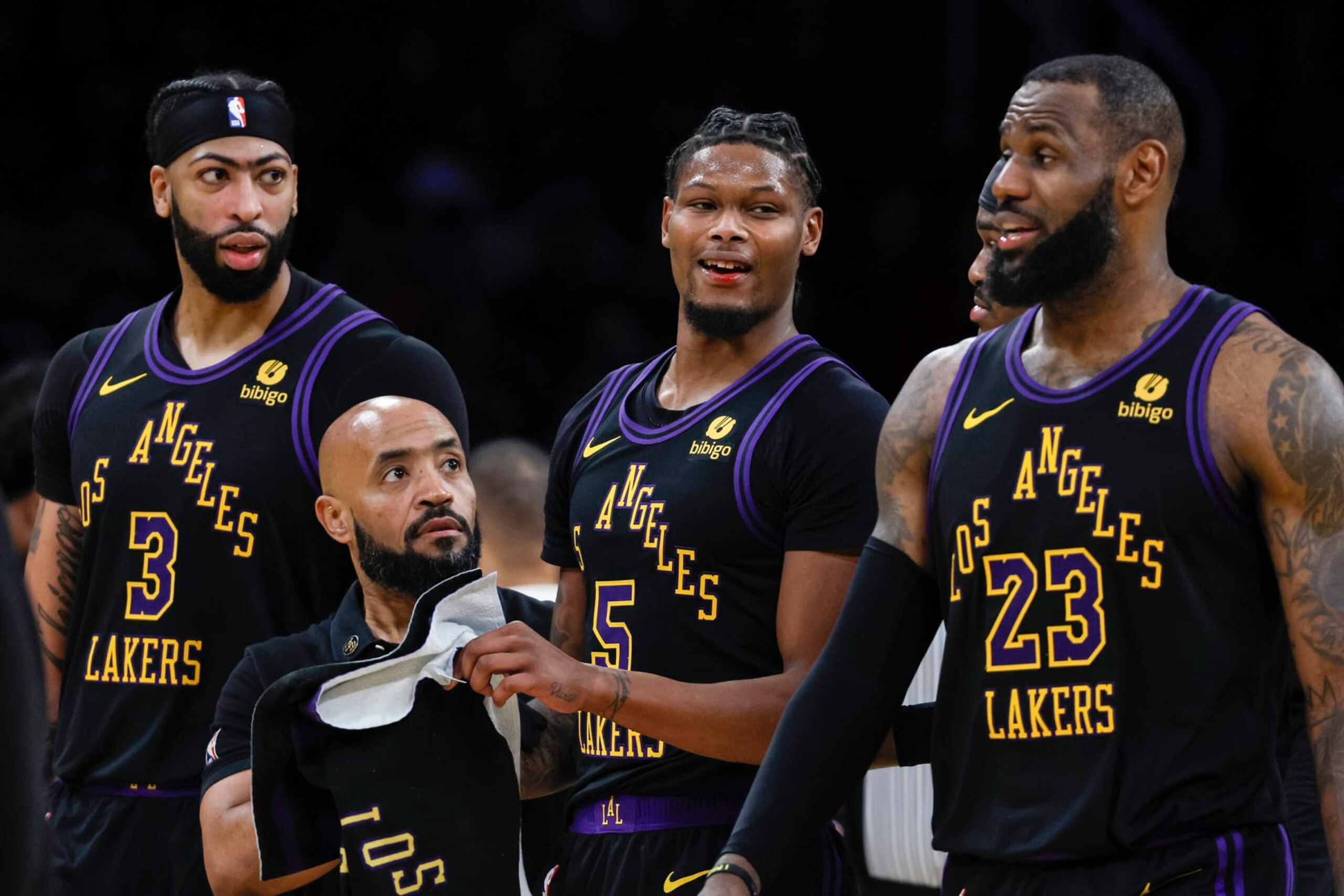 Los Angeles, CA, Tuesday, January 9, 2024 - Los Angeles Lakers forward Cam Reddish (5) is escorted by teammates after sustaining a bloody lip from the elbow of Toronto Raptors guard Immanuel Quickley (5) in the second half at Crypto.Com Arena. (Robert Gauthier/Los Angeles Times via Getty Images)