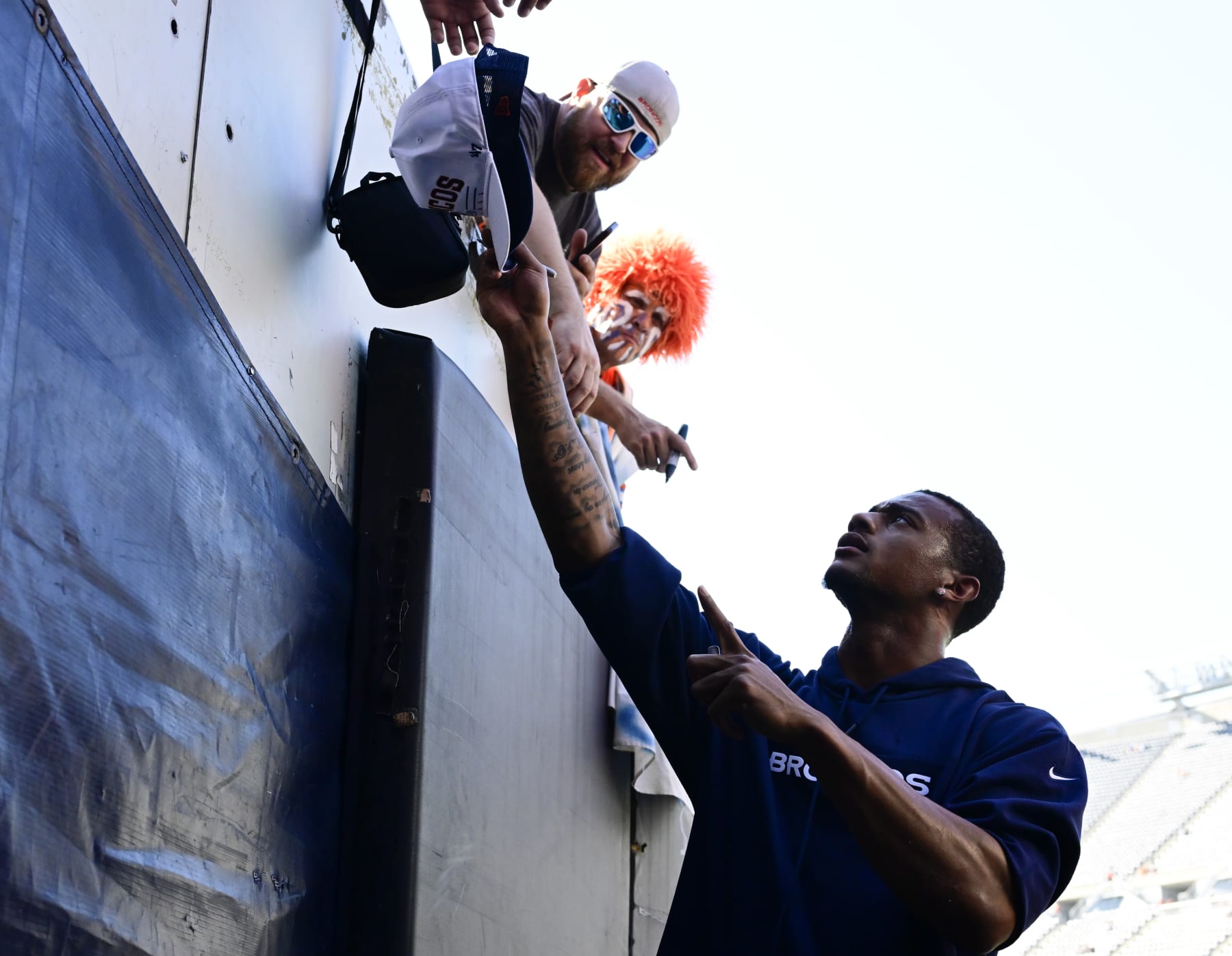 CHICAGO, IL - OCTOBER 01: Denver Broncos cornerback Pat Surtain II (2) hands a few autographed hats back to fans before the game against the Chicago Bears at Soldier Field in October 01, 2023. (Photo by Andy Cross/MediaNews Group/The Denver Post via Getty Images)