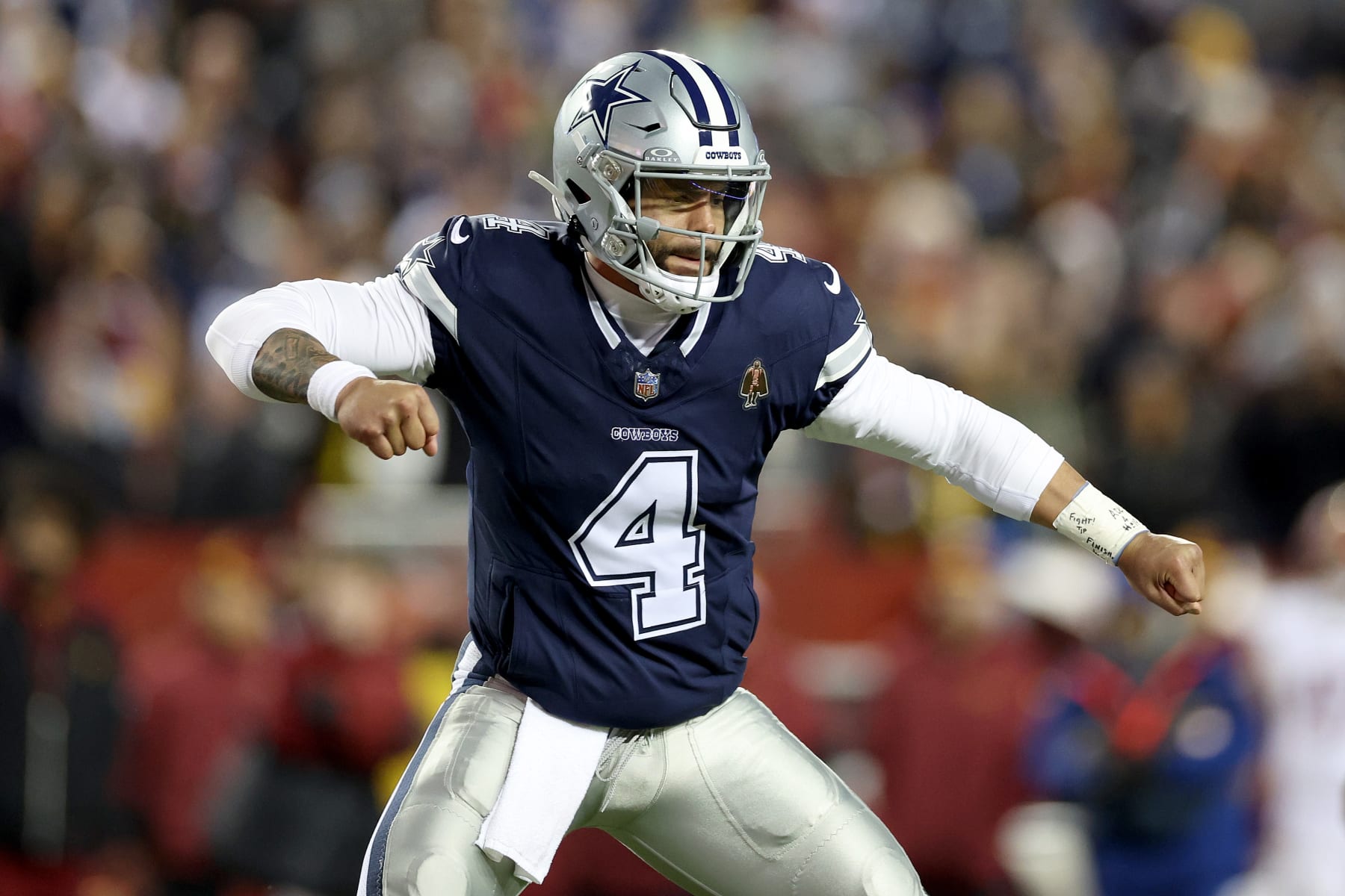 LANDOVER, MARYLAND - JANUARY 07: Dak Prescott #4 of the Dallas Cowboys celebrates a touchdown during the second quarter against the Washington Commanders at FedExField on January 07, 2024 in Landover, Maryland. (Photo by Patrick Smith/Getty Images)