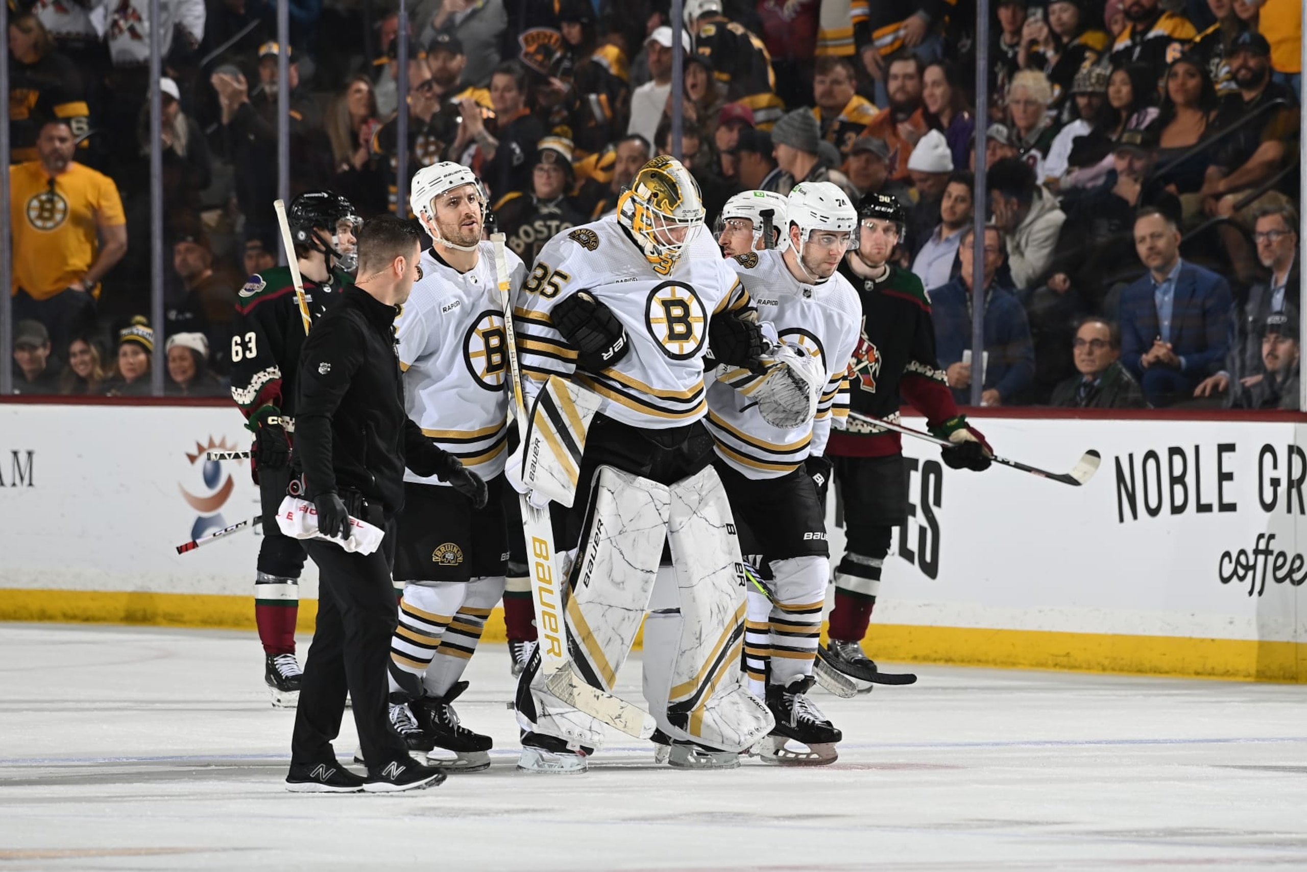 TEMPE, ARIZONA - JANUARY 09: Linus Ullmark #35 of the Boston Bruins is helped off the ice by teammates Kevin Shattenkirk #12 and Jake DeBrusk #74 during overtime against the Arizona Coyotes at Mullett Arena on January 09, 2024 in Tempe, Arizona. (Photo by Norm Hall/NHLI via Getty Images) TEMPE, ARIZONA - JANUARY 09: Linus Ullmark #35 of the Boston Bruins is helped off the ice by teammates Kevin Shattenkirk #12 and Jake DeBrusk #74 during overtime against the Arizona Coyotes at Mullett Arena on January 09, 2024 in Tempe, Arizona. (Photo by Norm Hall/NHLI via Getty Images)