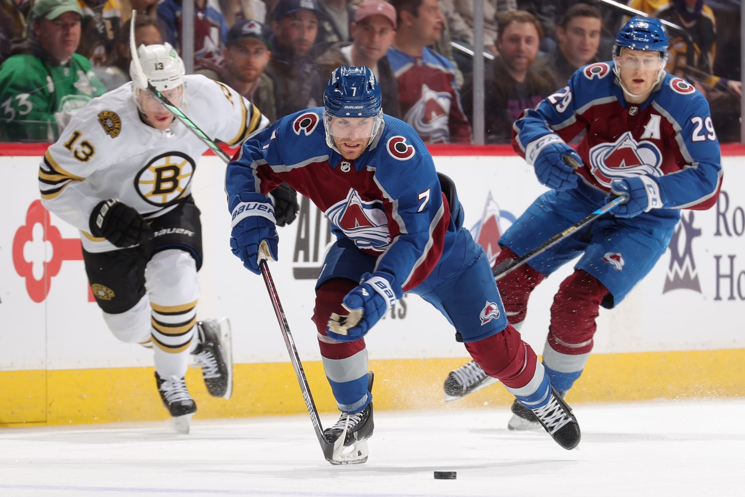 DENVER, COLORADO - JANUARY 08: Devon Toews #7 and Nathan MacKinnon #29 of the Colorado Avalanche skate against Charlie Coyle #13 of the Boston Bruins at Ball Arena on January 8, 2024 in Denver, Colorado. (Photo by Michael Martin/NHLI via Getty Images) DENVER, COLORADO - JANUARY 08: Devon Toews #7 and Nathan MacKinnon #29 of the Colorado Avalanche skate against Charlie Coyle #13 of the Boston Bruins at Ball Arena on January 8, 2024 in Denver, Colorado. (Photo by Michael Martin/NHLI via Getty Images)