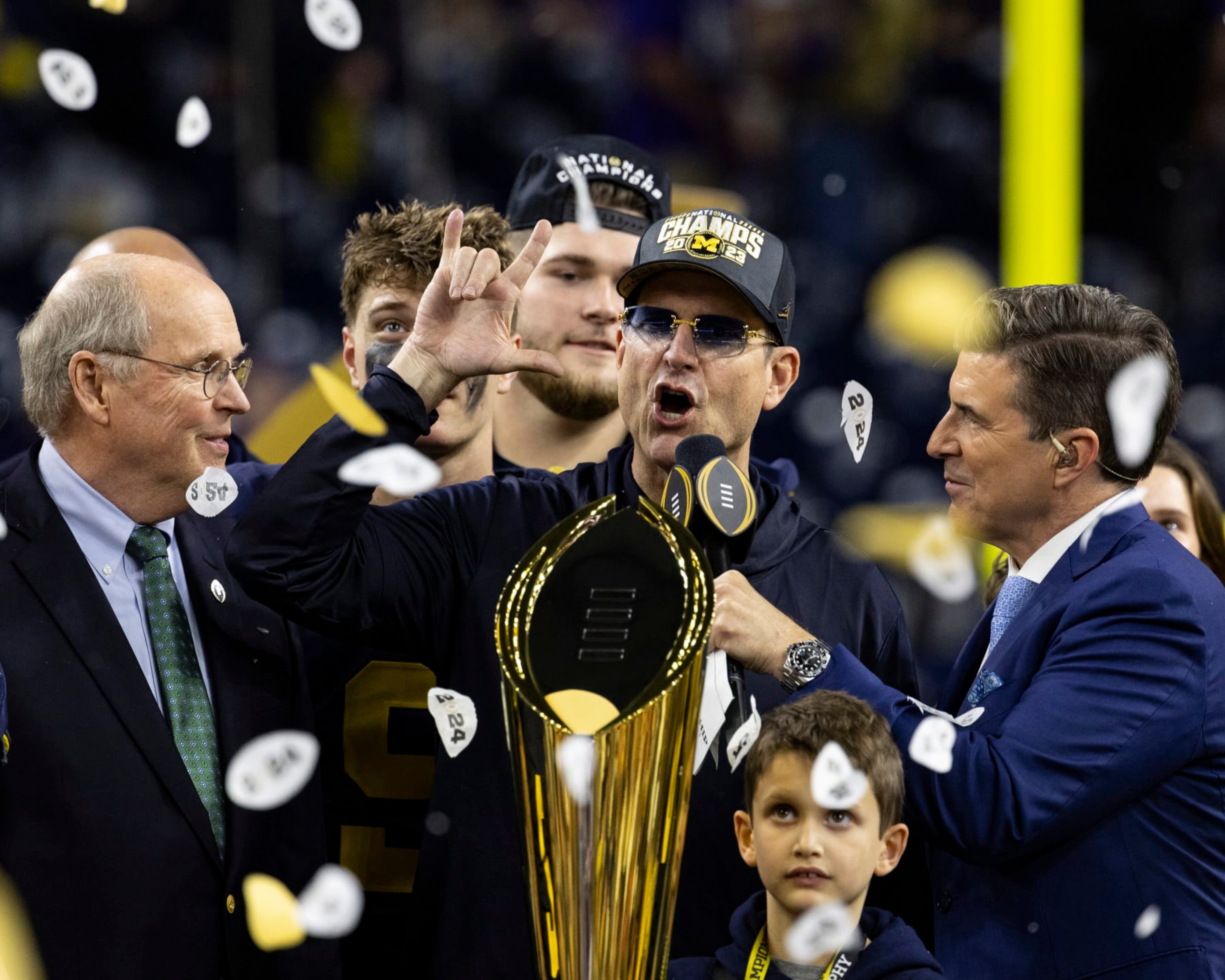 HOUSTON, TX - JANUARY 8: Head Coach Jim Harbaugh of the Michigan Wolverines is interviewed during the trophy presentation after the CFP National Championship game between University of Washington and University of Michigan at NRG Stadium on January 8, 2024 in Houston, Texas. (Photo by Steve Limentani/ISI Photos/Getty Images) HOUSTON, TX - JANUARY 8: Head Coach Jim Harbaugh of the Michigan Wolverines is interviewed during the trophy presentation after the CFP National Championship game between University of Washington and University of Michigan at NRG Stadium on January 8, 2024 in Houston, Texas. (Photo by Steve Limentani/ISI Photos/Getty Images)
