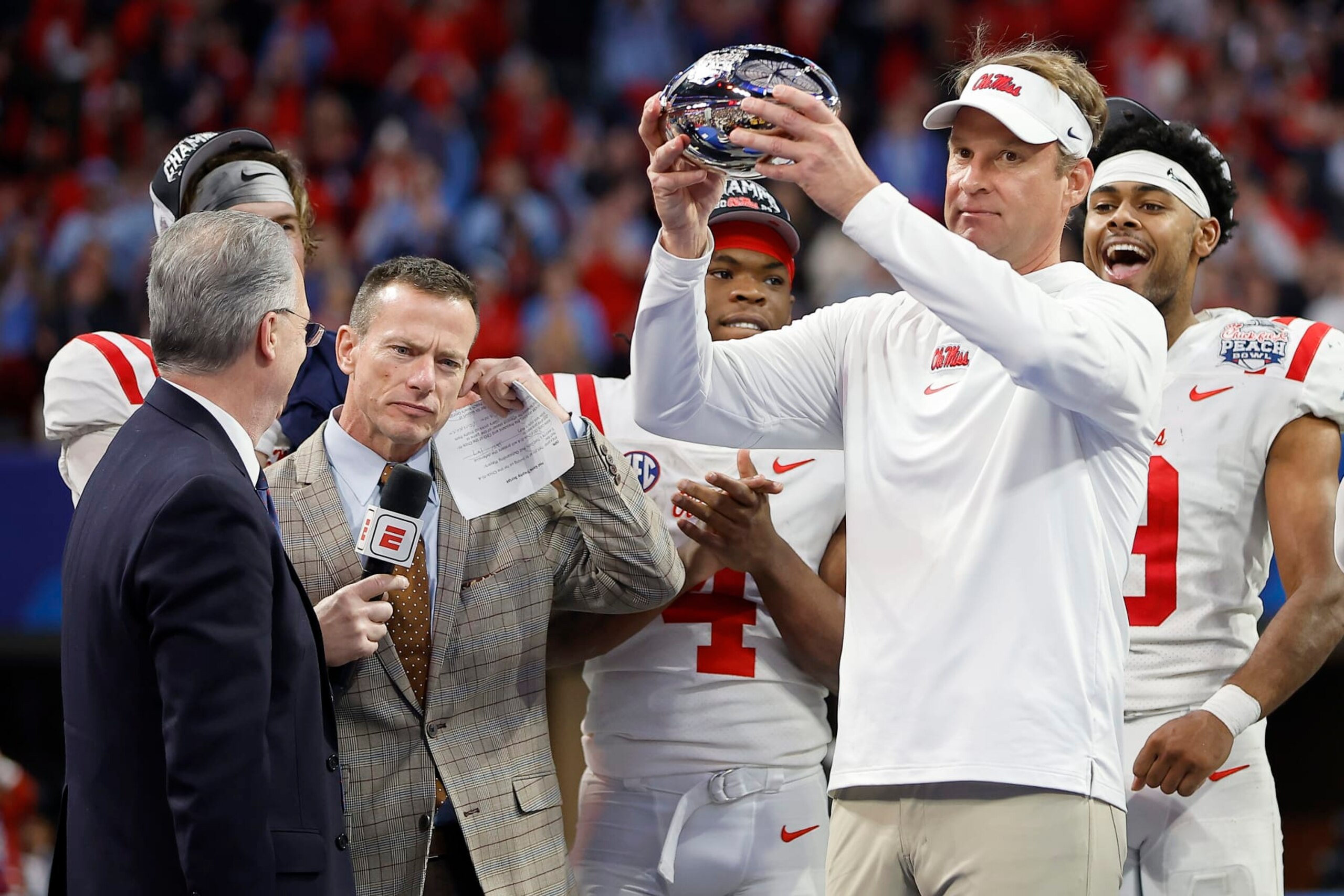 ATLANTA, GEORGIA - DECEMBER 30: Head coach Lane Kiffin of the Mississippi Rebels celebrates with the team after beating Penn State Nittany Lions during the Chick-fil-A Peach Bowl at Mercedes-Benz Stadium on December 30, 2023 in Atlanta, Georgia. (Photo by Alex Slitz/Getty Images)