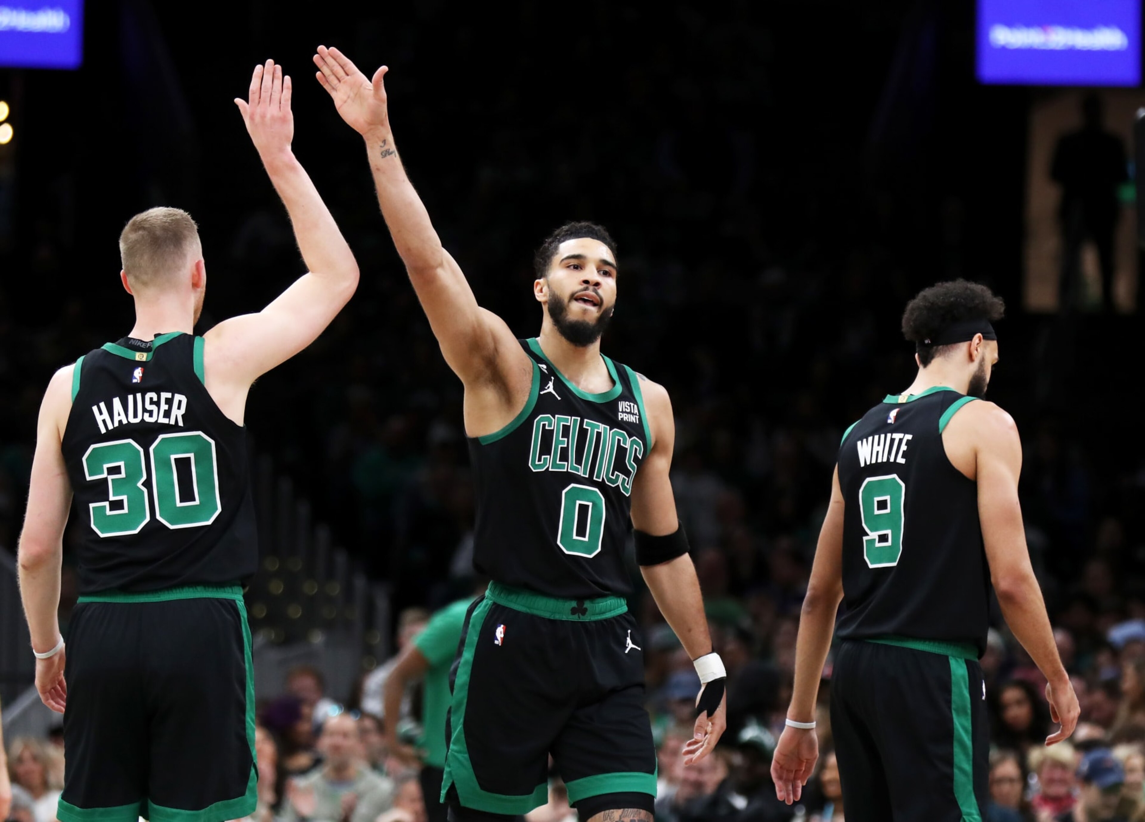 BOSTON, MASSACHUSETTS - APRIL 07: Jayson Tatum #0 and Sam Hauser #30 of the Boston Celtics high five during the first quarter of the game against the Toronto Raptors at TD Garden on April 07, 2023 in Boston, Massachusetts. NOTE TO USER: User expressly acknowledges and agrees that, by downloading and or using this photograph, User is consenting to the terms and conditions of the Getty Images License Agreement. (Photo by Omar Rawlings/Getty Images)