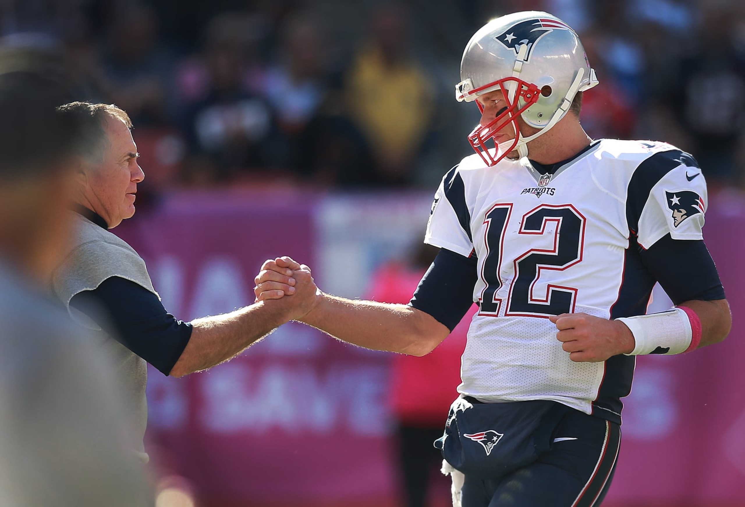CLEVELAND - OCTOBER 9: New England Patriots quarterback Tom Brady, right, gets a hand from head coach Bill Belichick (left) as he came to the sidelines after being removed from the game in the fourth quarter. The New England Patriots visited the Cleveland Browns in a regular season NFL football game at FirstEnergy Stadium in Cleveland on Oct. 9, 2016. (Photo by Jim Davis/The Boston Globe via Getty Images)