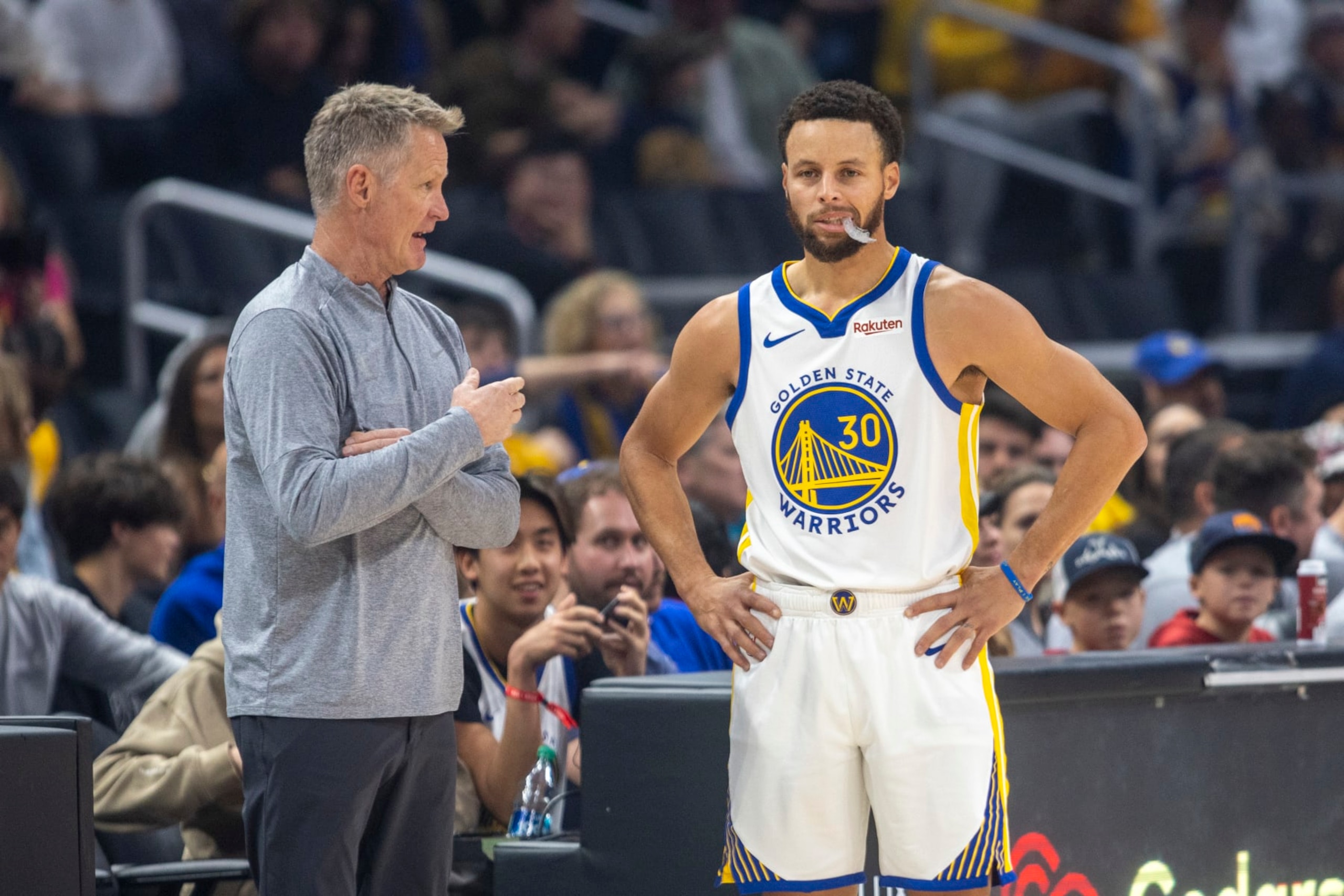 LOS ANGELES, CA - DECEMBER 02: Golden State Warriors head coach Steve Kerr talks with Golden State Warriors guard Stephen Curry (30) courtside during a break in the first half of an NBA basketball game between the Golden State Warriors and Los Angeles Clippers, Saturday, December 2, 2023, at Crypto.com Arena in Los Angeles, California. (Photo by Tony Ding/Icon Sportswire via Getty Images)