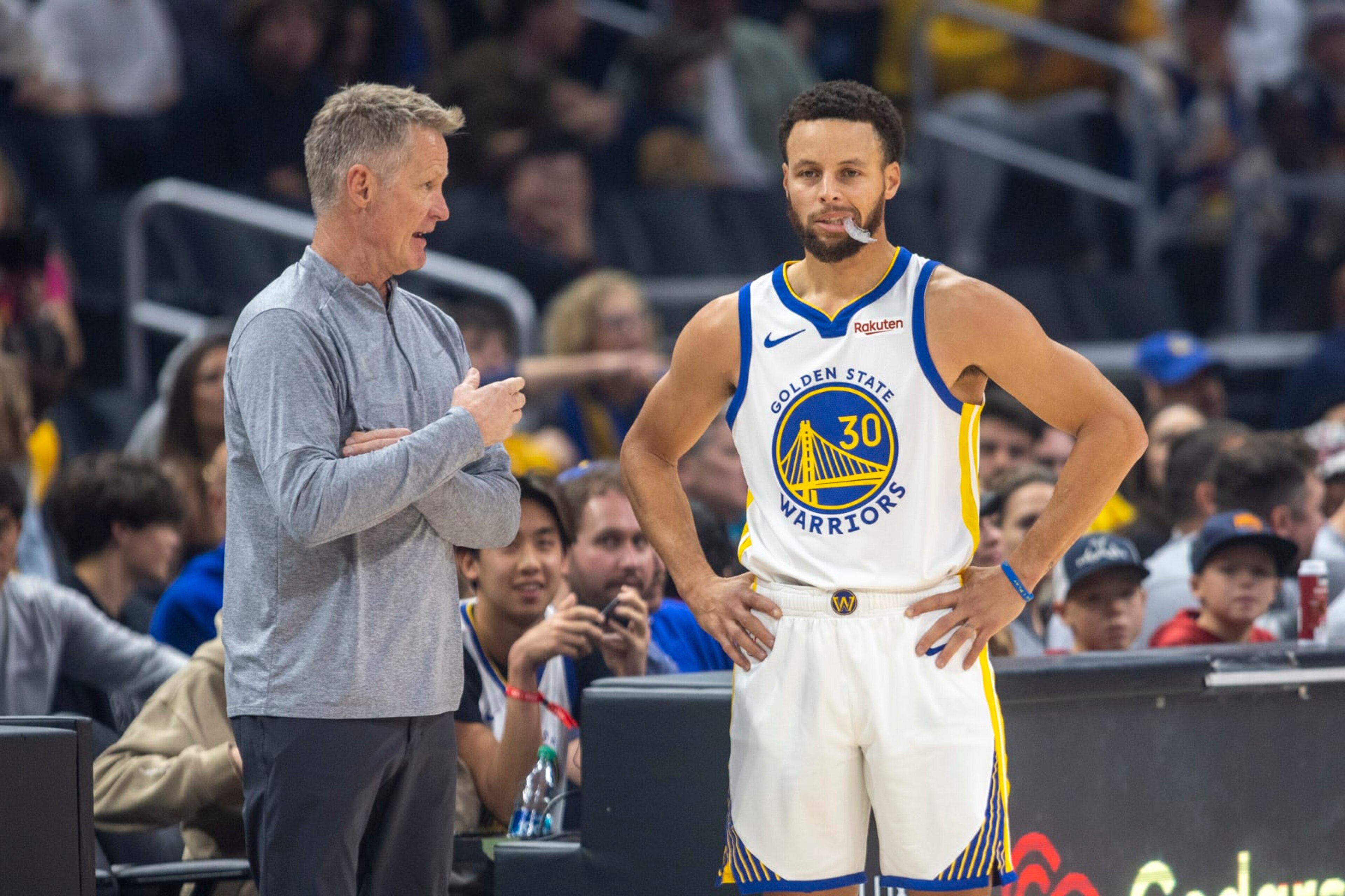 LOS ANGELES, CA - DECEMBER 02: Golden State Warriors head coach Steve Kerr talks with Golden State Warriors guard Stephen Curry (30) courtside during a break in the first half of an NBA basketball game between the Golden State Warriors and Los Angeles Clippers, Saturday, December 2, 2023, at Crypto.com Arena in Los Angeles, California. (Photo by Tony Ding/Icon Sportswire via Getty Images)