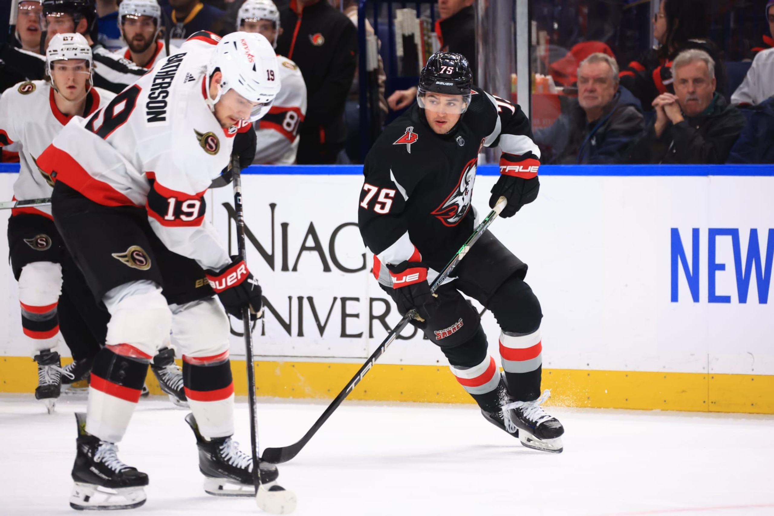 BUFFALO, NEW YORK - JANUARY 11: Drake Batherson #19 of the Ottawa Senators controls the puck against Connor Clifton #75 of the Buffalo Sabres during an NHL game on January 11, 2024 at KeyBank Center in Buffalo, New York. (Photo by Bill Wippert/NHLI via Getty Images)