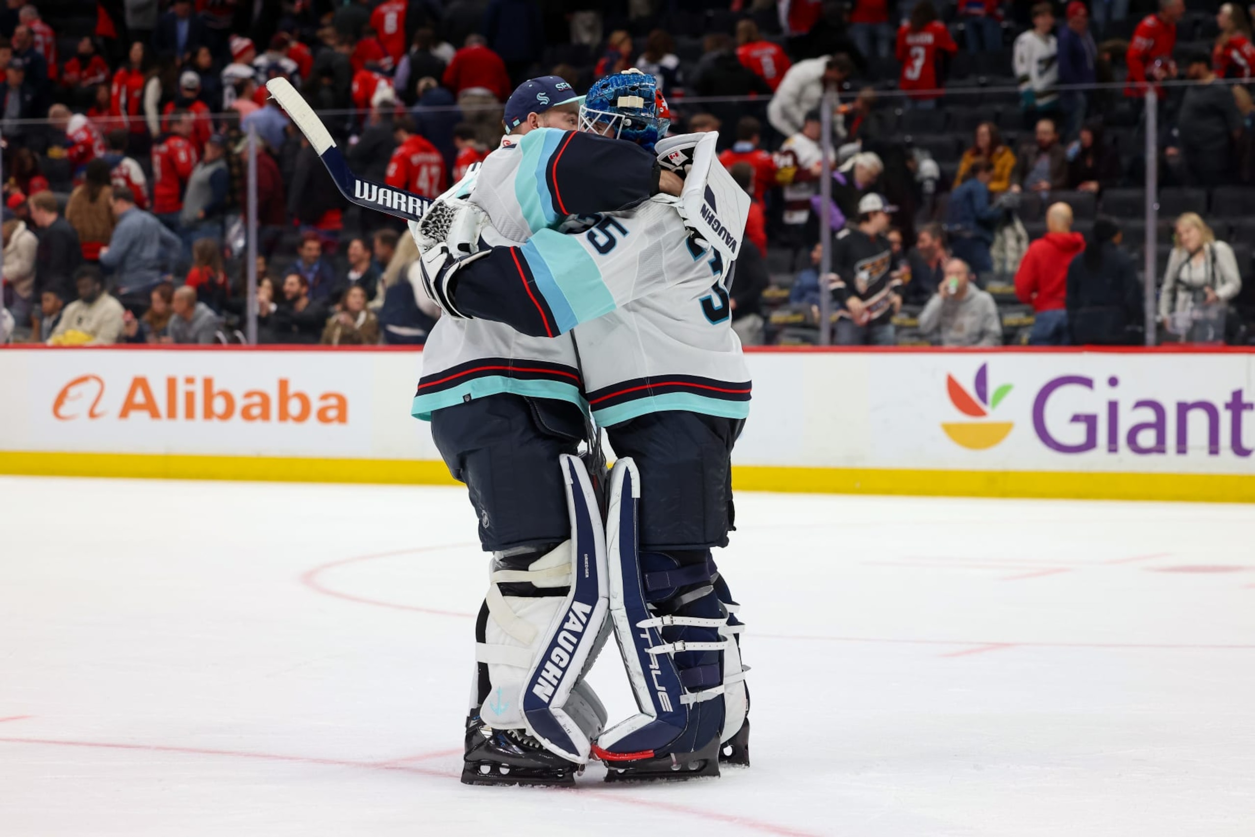 WASHINGTON, DC - JANUARY 11: Joey Daccord #35 of the Seattle Kraken celebrates a win against the Washington Capitals with Chris Driedger at Capital One Arena on January 11, 2024 in Washington, D.C. (Photo by John McCreary/NHLI via Getty Images)