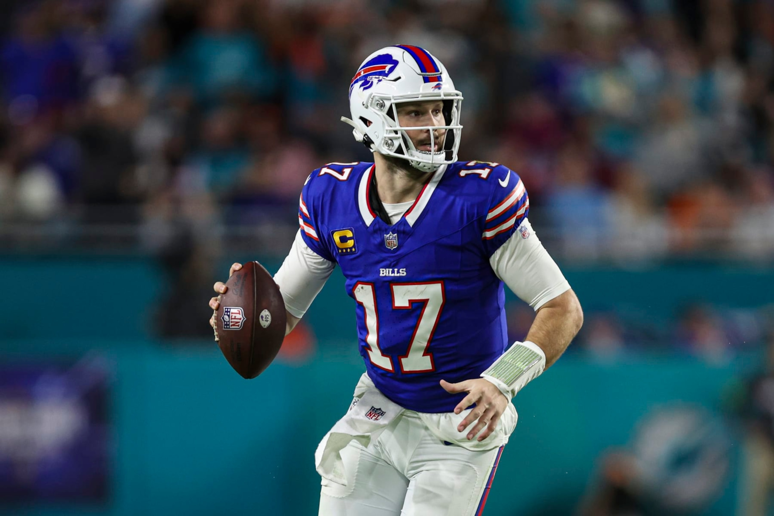 MIAMI GARDENS, FL - JANUARY 07: Josh Allen #17 of the Buffalo Bills scrambles out of the pocket during an NFL football game against the Miami Dolphins at Hard Rock Stadium on January 7, 2024 in Miami Gardens, Florida. (Photo by Perry Knotts/Getty Images)