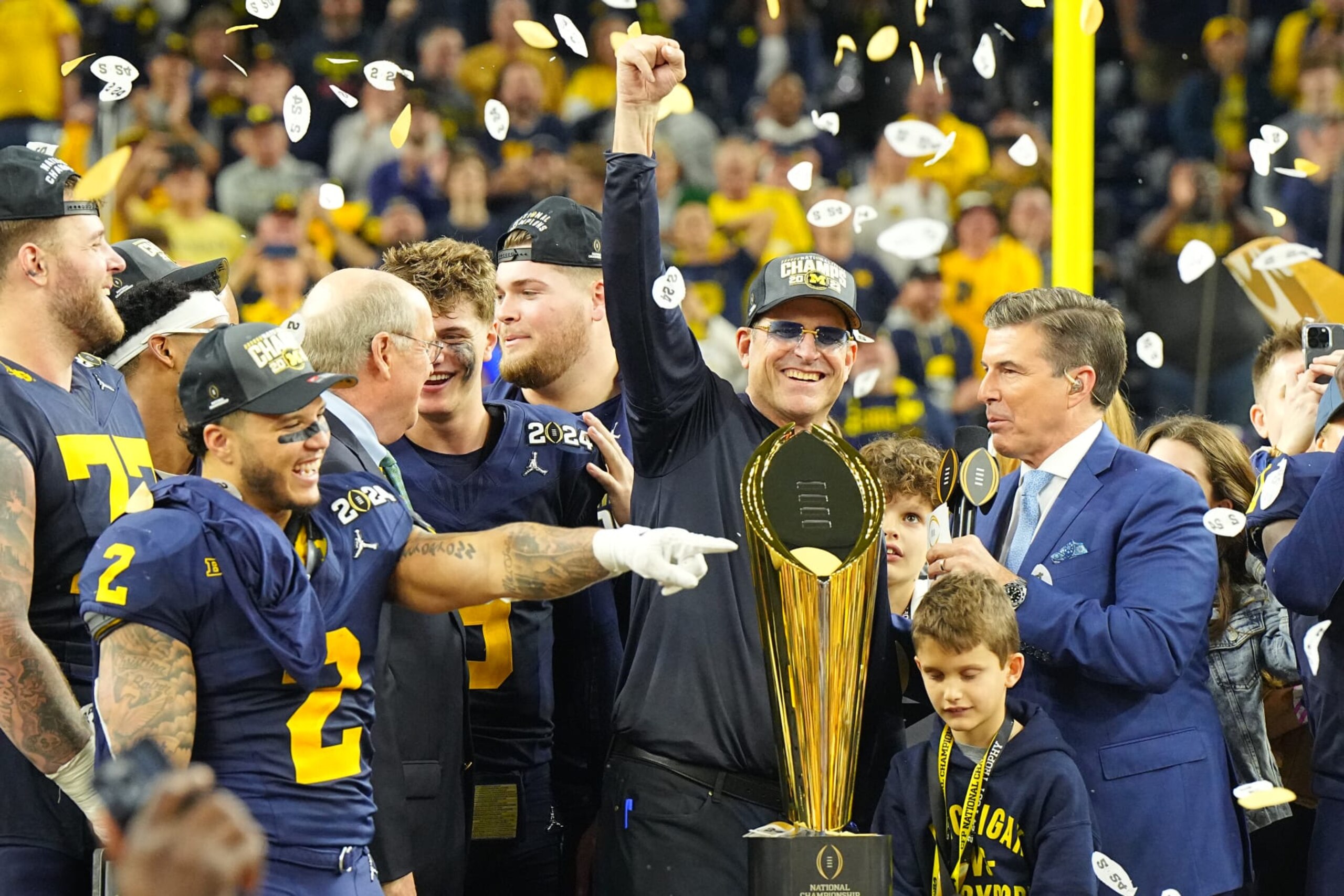 College Football: CFP National Championship: Michigan head coach Jim harbaugh hoists the championship trophy following victory vs Washington at NRG Stadium. 
Houston, TX 1/8/2024
CREDIT: Erick W. Rasco (Photo by Erick W. Rasco/Sports Illustrated via Getty Images) 
(Set Number: X164476 TK1)