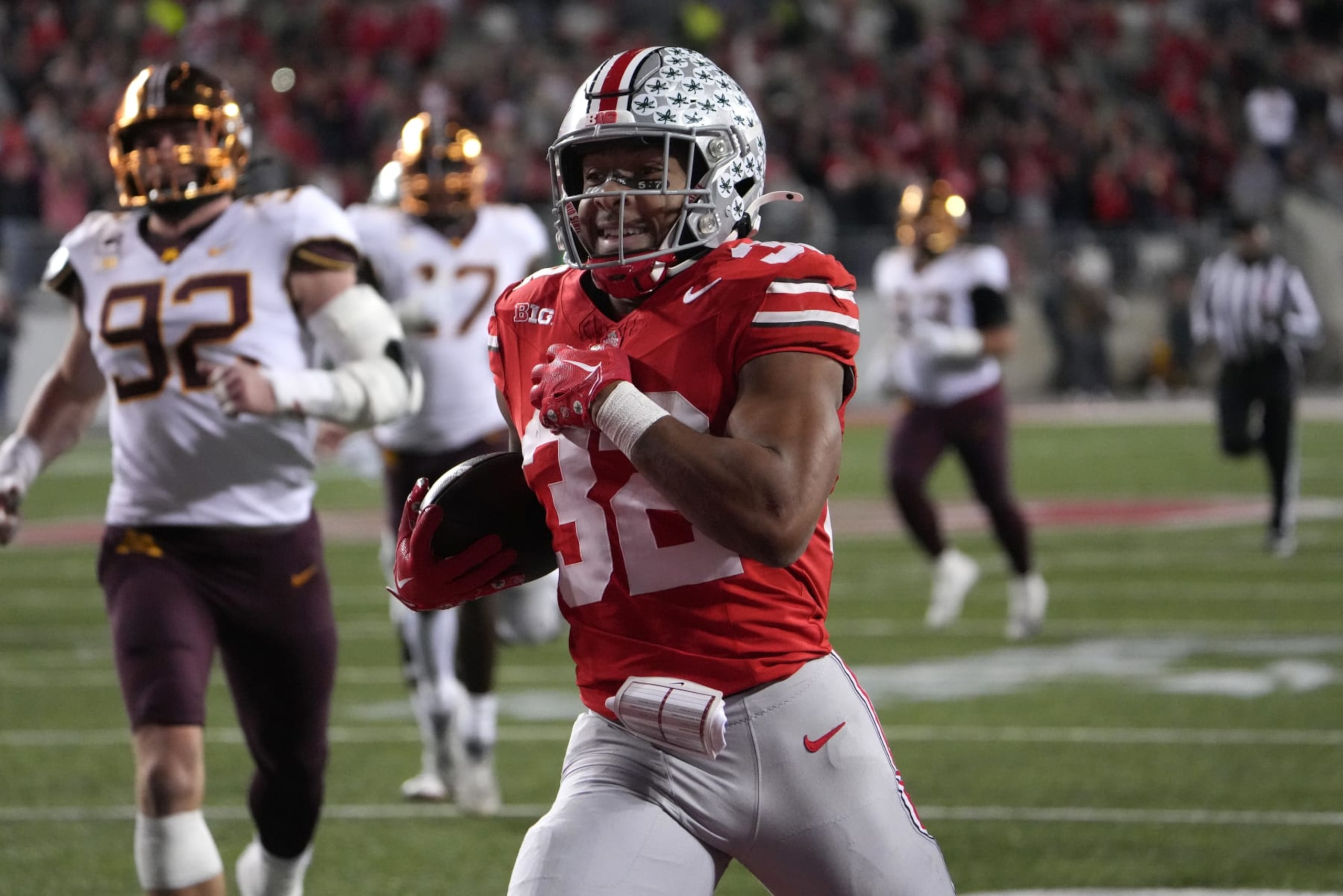 COLUMBUS, OHIO - NOVEMBER 18: Running back TreVeyon Henderson #32 of the Ohio State Buckeyes carries the ball during the game against the Minnesota Golden Gophers at Ohio Stadium on November 18, 2023 in Columbus, Ohio. (Photo by Jason Mowry/Getty Images)