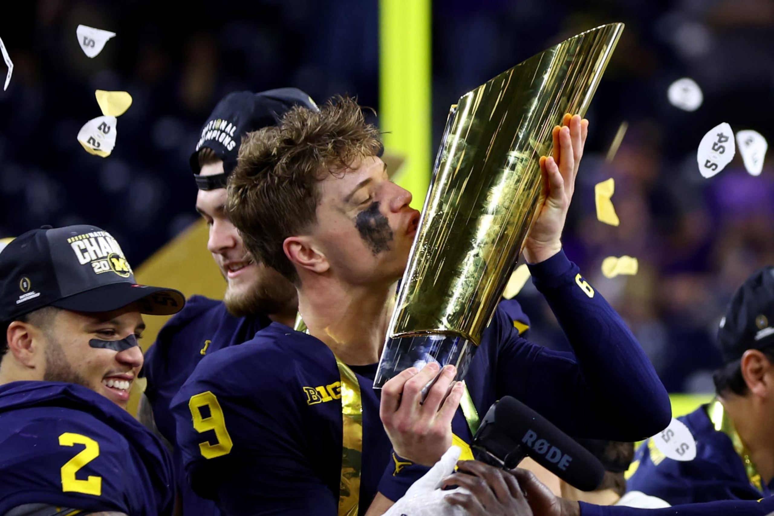 HOUSTON, TEXAS - JANUARY 08: J.J. McCarthy #9 of the Michigan Wolverines kisses the national championship trophy after defeating the Washington Huskies during the 2024 CFP National Championship game at NRG Stadium on January 08, 2024 in Houston, Texas. Michigan defeated Washington 34-13. (Photo by Maddie Meyer/Getty Images)