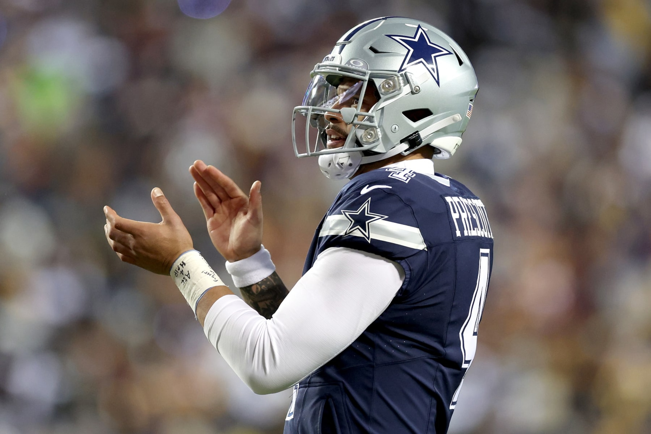 LANDOVER, MARYLAND - JANUARY 07: Dak Prescott #4 of the Dallas Cowboys reacts during the first half against the Washington Commanders at FedExField on January 07, 2024 in Landover, Maryland. (Photo by Patrick Smith/Getty Images)