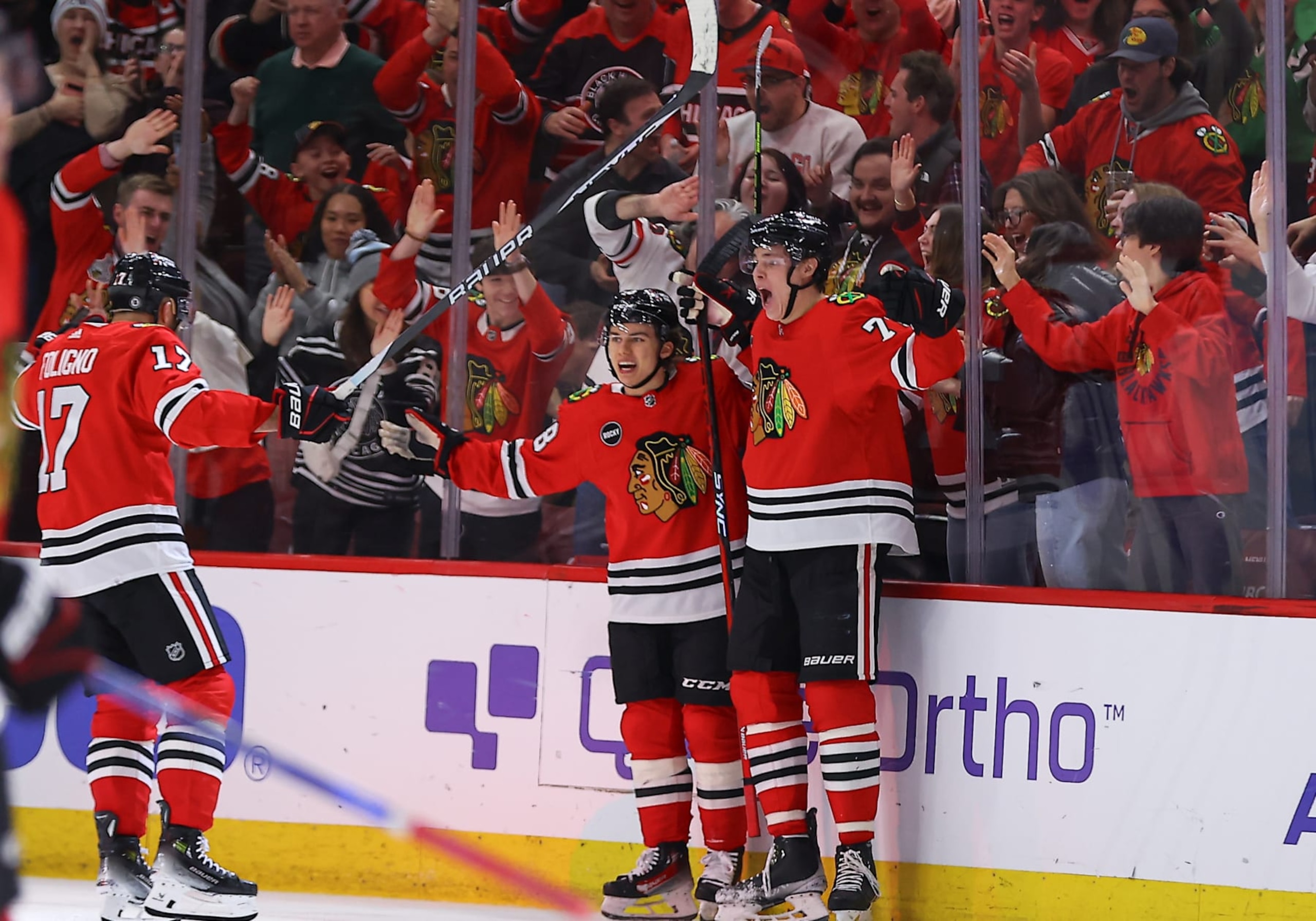 CHICAGO, IL - DECEMBER 27: Connor Bedard #98 of the Chicago Blackhawks celebrates with Alex Vlasic #72 and  Nick Foligno #17 of the Chicago Blackhawks of the Chicago Blackhawks after a goal during overtime against the Winnipeg Jets at the United Center on December  27, 2023 in Chicago, Illinois. (Photo by Melissa Tamez/Icon Sportswire via Getty Images)