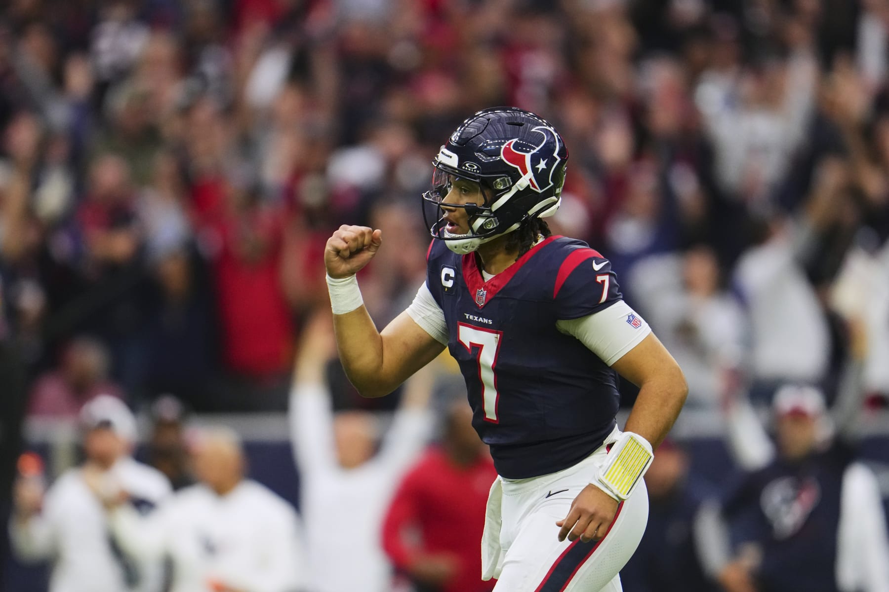 HOUSTON, TX - JANUARY 13: C.J. Stroud #7 of the Houston Texans celebrates after scoring a touchdown against the Cleveland Browns during the first half of the AFC Wild Card playoff game at NRG Stadium on January 13, 2024 in Houston, Texas. (Photo by Cooper Neill/Getty Images)