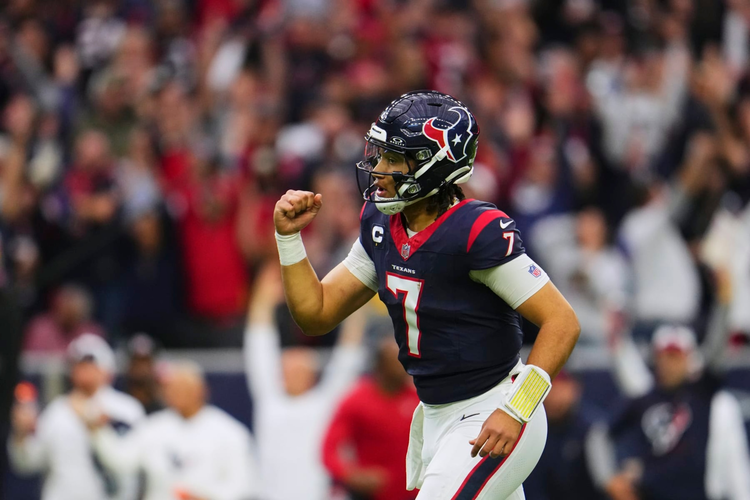HOUSTON, TX - JANUARY 13: C.J. Stroud #7 of the Houston Texans celebrates after scoring a touchdown against the Cleveland Browns during the first half of the AFC Wild Card playoff game at NRG Stadium on January 13, 2024 in Houston, Texas. (Photo by Cooper Neill/Getty Images)