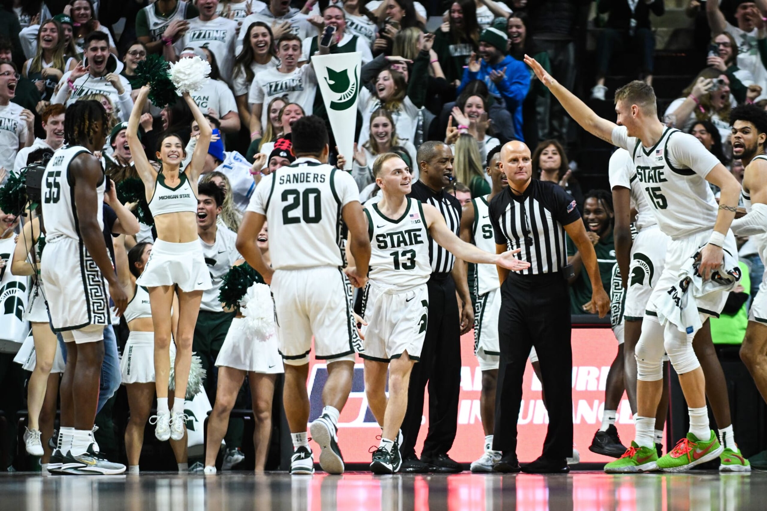 EAST LANSING, MI - JANUARY 14: Michigan State Spartans guard Steven Izzo (13) gets congratulated by teammates after scoring the first points of his career during a college basketball game between the Michigan State Spartans and the Rutgers Scarlet Knights on January 14, 2024, at the Breslin Center in East Lansing, MI. (Photo by Adam Ruff/Icon Sportswire via Getty Images) EAST LANSING, MI - JANUARY 14: Michigan State Spartans guard Steven Izzo (13) gets congratulated by teammates after scoring the first points of his career during a college basketball game between the Michigan State Spartans and the Rutgers Scarlet Knights on January 14, 2024, at the Breslin Center in East Lansing, MI. (Photo by Adam Ruff/Icon Sportswire via Getty Images)