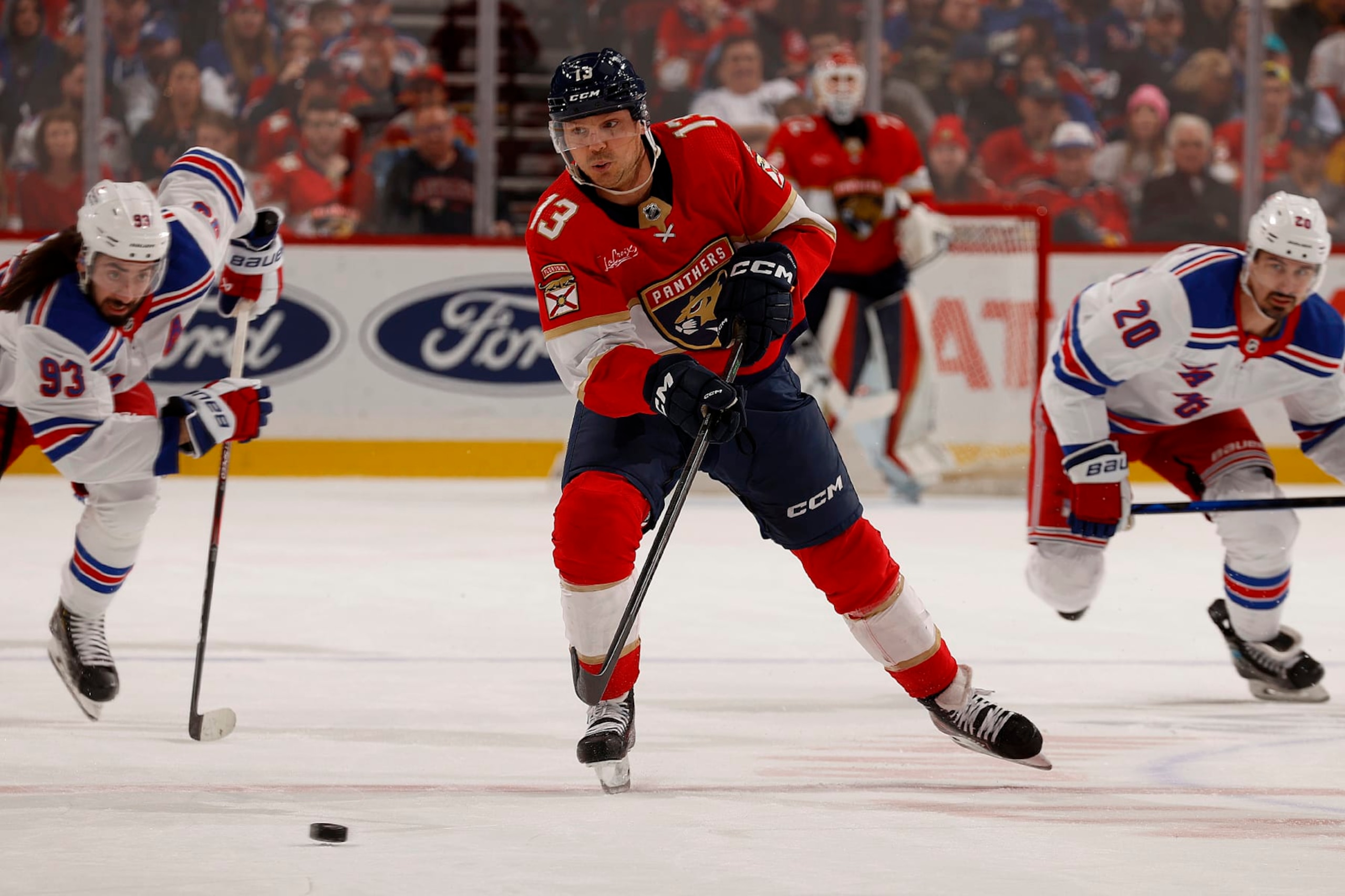 SUNRISE, FLORIDA - DECEMBER 29: Sam Reinhart #13 of the Florida Panthers skates for possession against the New York Rangers at the Amerant Bank Arena on December 29, 2023 in Sunrise, Florida. (Photo by Eliot J. Schechter/NHLI via Getty Images)