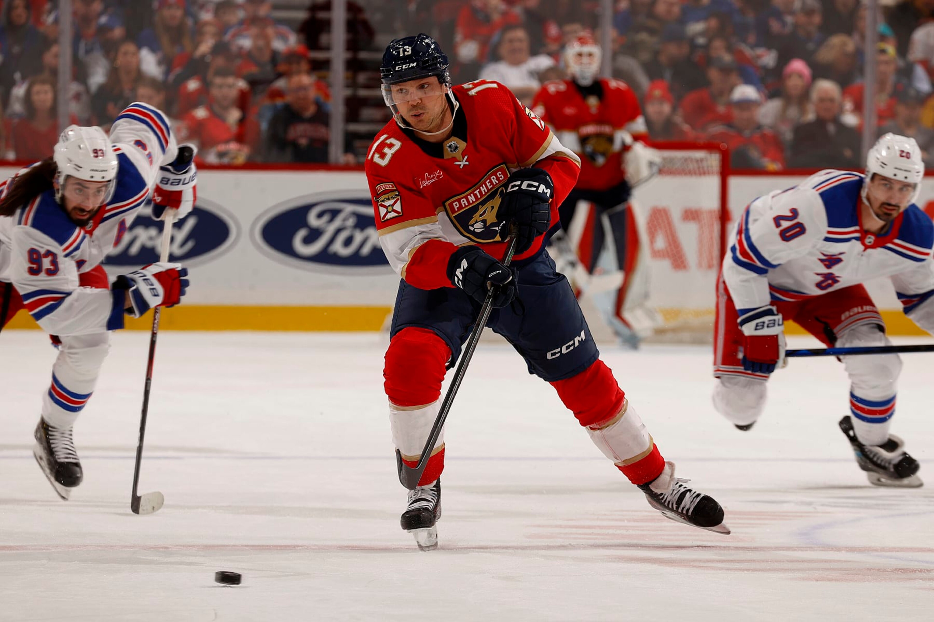 SUNRISE, FLORIDA - DECEMBER 29: Sam Reinhart #13 of the Florida Panthers skates for possession against the New York Rangers at the Amerant Bank Arena on December 29, 2023 in Sunrise, Florida. (Photo by Eliot J. Schechter/NHLI via Getty Images) SUNRISE, FLORIDA - DECEMBER 29: Sam Reinhart #13 of the Florida Panthers skates for possession against the New York Rangers at the Amerant Bank Arena on December 29, 2023 in Sunrise, Florida. (Photo by Eliot J. Schechter/NHLI via Getty Images)
