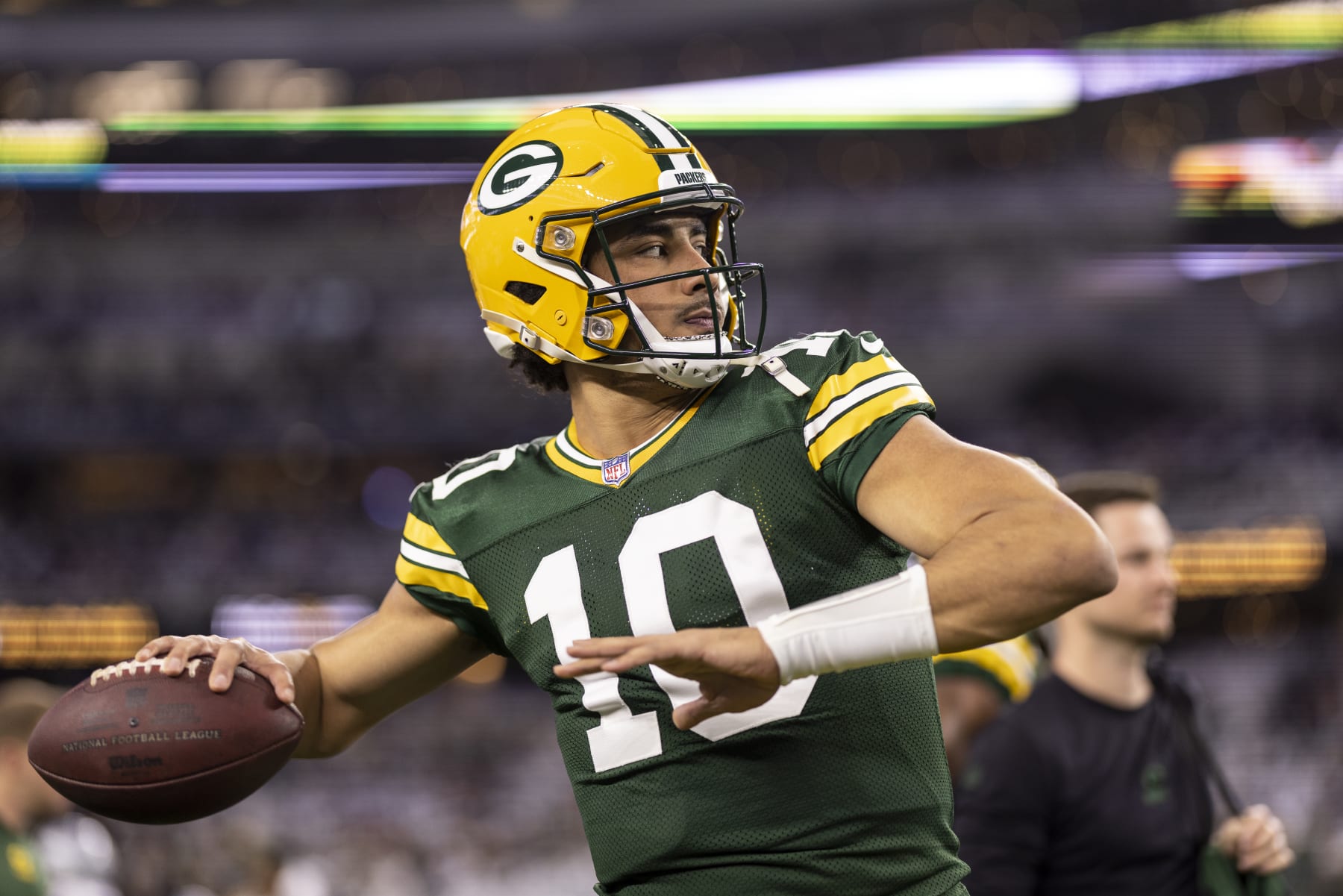 ARLINGTON, TEXAS - JANUARY 14: Jordan Love #10 of the Green Bay Packers throws a pass as he warms up prior to an NFL wild-card playoff football game between the Dallas Cowboys and the Green Bay Packers at AT&T Stadium on January 14, 2024 in Arlington, Texas. (Photo by Michael Owens/Getty Images)
