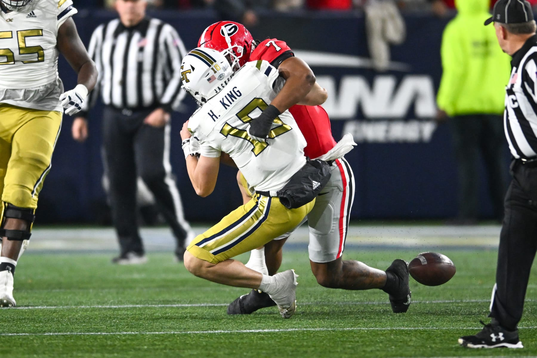 ATLANTA, GA  NOVEMBER 25:  Georgia Tech quarterback Haynes King (10) fumbles the ball after being hit by Georgia linebacker Marvin Jones Jr. (7) during the college football game between the Georgia Bulldogs and the Georgia Tech Yellow Jackets on November 25th, 2023 at Bobby Dodd Stadium in Atlanta, GA.  (Photo by Rich von Biberstein/Icon Sportswire via Getty Images)
