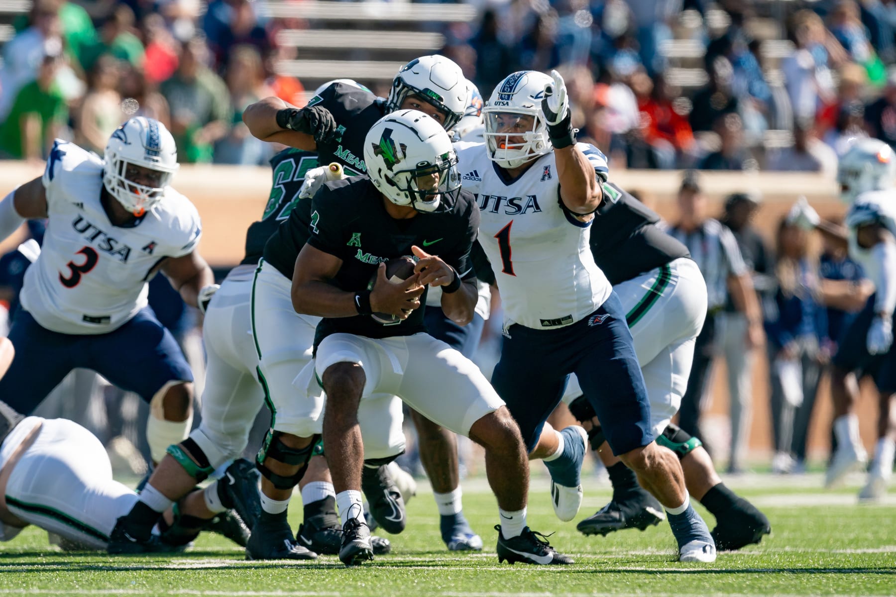DENTON, TX - NOVEMBER 04: North Texas Mean Green quarterback Chandler Rogers (4) is pressured by UTSA Roadrunners linebacker Trey Moore (1) during the UTSA Roadrunners  and North Texas Mean Green on November 4, 2023 at Apogee Stadium, TX. (Photo by Christopher Leduc/Icon Sportswire via Getty Images)