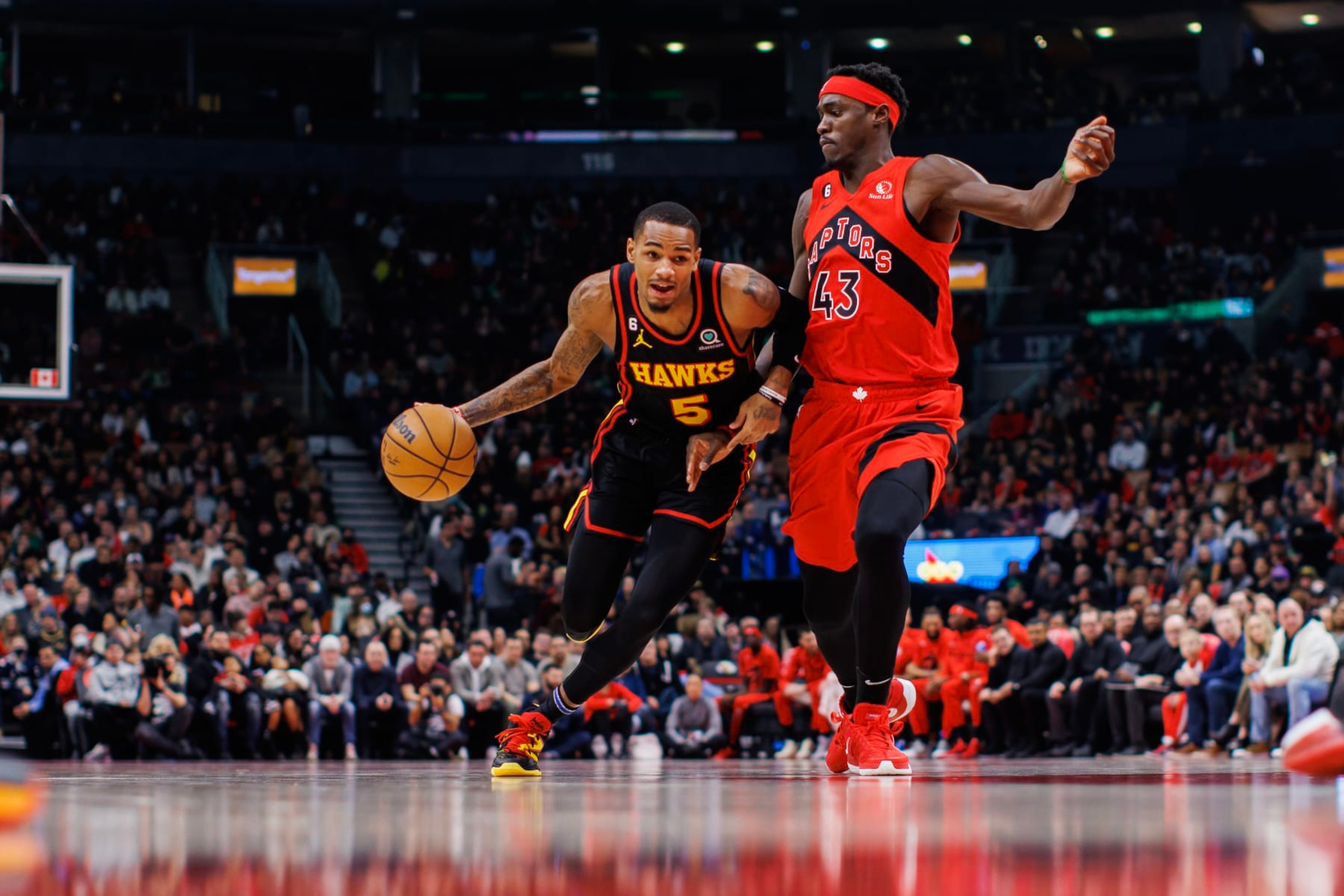 TORONTO, ON - JANUARY 14: Dejounte Murray #5 of the Atlanta Hawks dribbles against Pascal Siakam #43 of the Toronto Raptors during the first half of their NBA game at Scotiabank Arena on January 14, 2023 in Toronto, Canada. NOTE TO USER: User expressly acknowledges and agrees that, by downloading and or using this photograph, User is consenting to the terms and conditions of the Getty Images License Agreement. (Photo by Cole Burston/Getty Images)