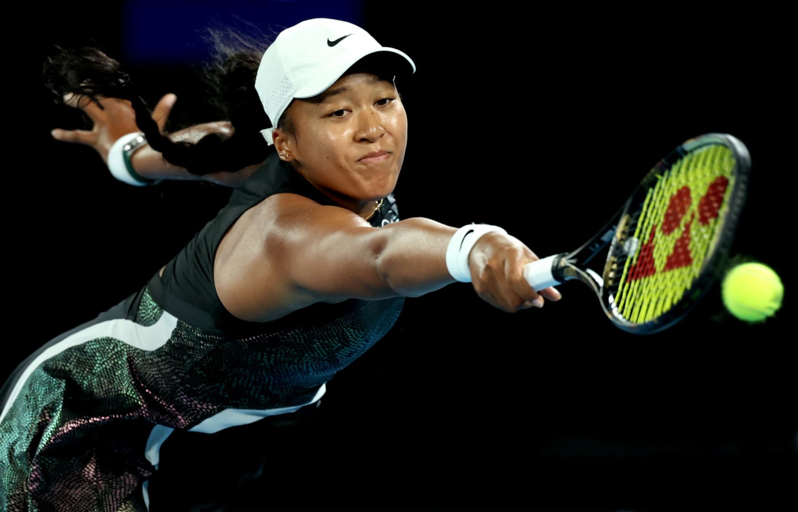 MELBOURNE, AUSTRALIA - JANUARY 15: Naomi Osaka of Japan plays a backhand in their round one singles match against Caroline Garcia of France during the 2024 Australian Open at Melbourne Park on January 15, 2024 in Melbourne, Australia. (Photo by Cameron Spencer/Getty Images)