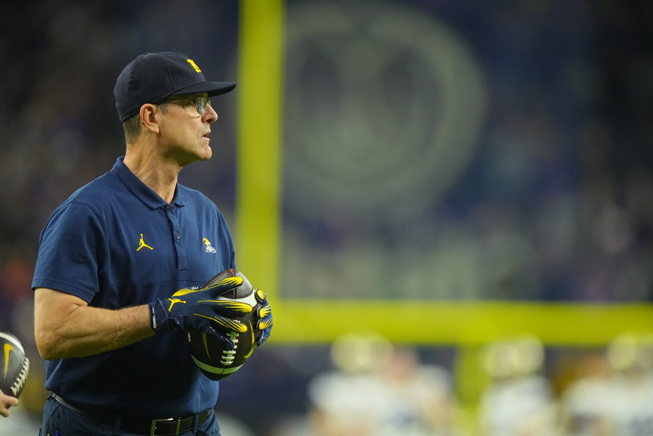 College Football: CFP National Championship: Michigan head coach Jim Harbaugh throws a follow prior to game vs Washington at NRG Stadium. 
Houston, TX 1/8/2024
CREDIT: Erick W. Rasco (Photo by Erick W. Rasco/Sports Illustrated via Getty Images) 
(Set Number: X164476 TK1)