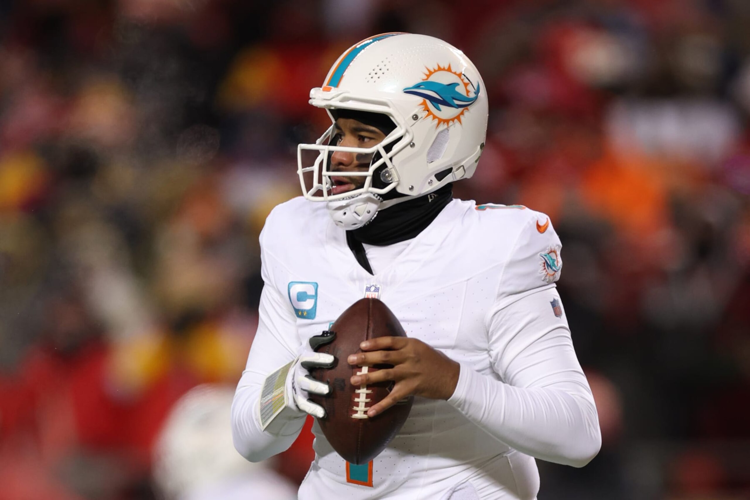 KANSAS CITY, MISSOURI - JANUARY 13: Tua Tagovailoa #1 of the Miami Dolphins looks to pass during the first half against the Kansas City Chiefs in the AFC Wild Card Playoffs at GEHA Field at Arrowhead Stadium on January 13, 2024 in Kansas City, Missouri. (Photo by Jamie Squire/Getty Images)