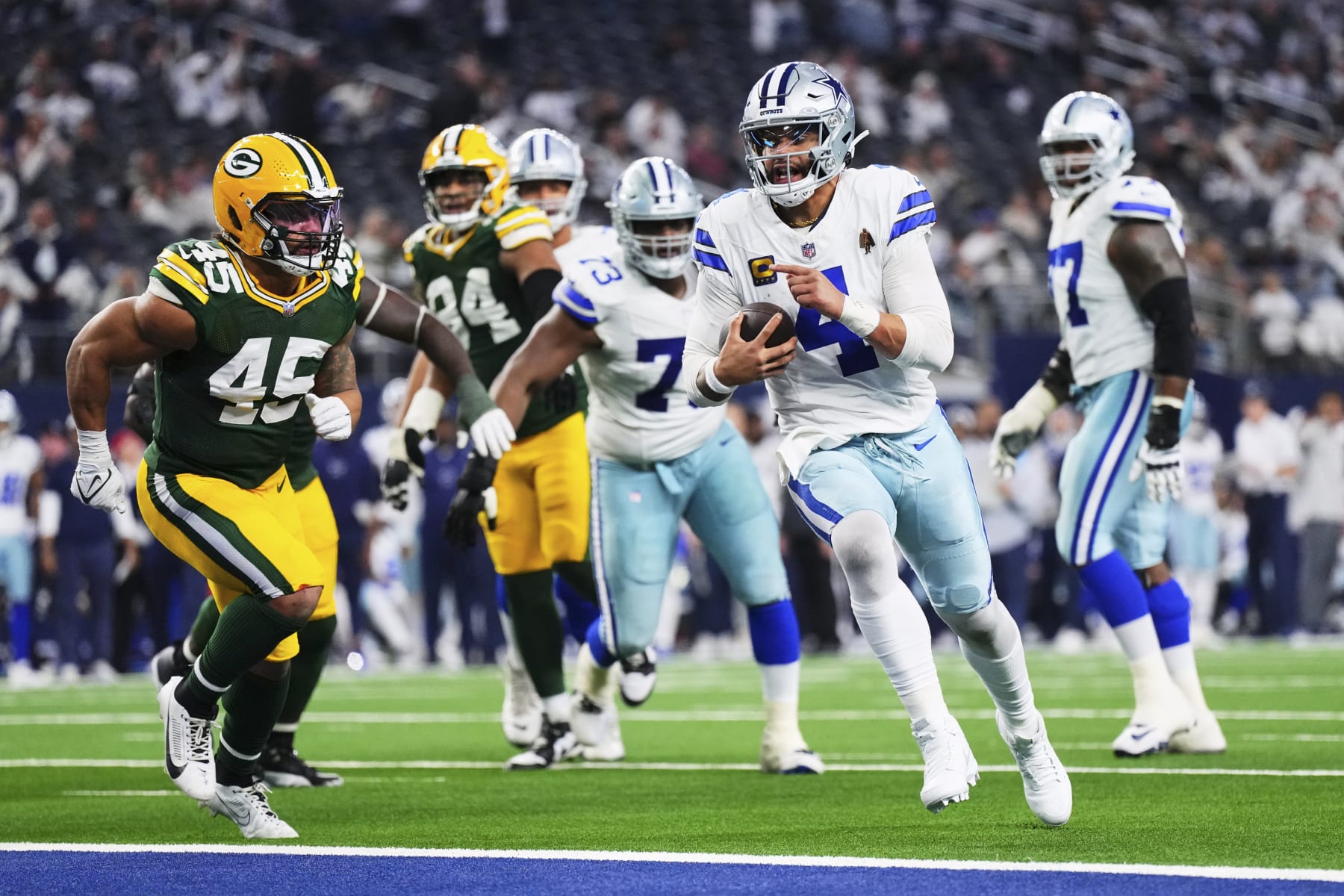DALLAS, TX - JANUARY 14: Dak Prescott #4 of the Dallas Cowboys runs into the end zone for a two-point conversion against the Green Bay Packers during the second half of the NFC Wild Card playoff game at AT&T Stadium on January 14, 2024 in Dallas, Texas. (Photo by Cooper Neill/Getty Images)