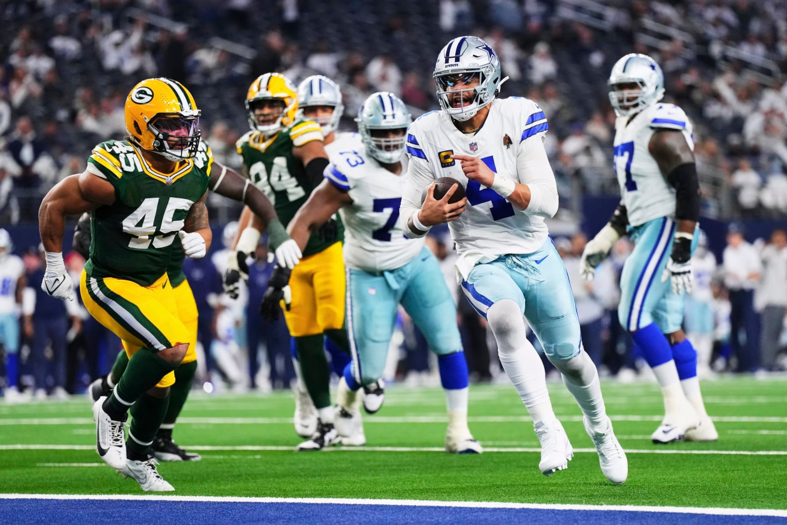 DALLAS, TX - JANUARY 14: Dak Prescott #4 of the Dallas Cowboys runs into the end zone for a two-point conversion against the Green Bay Packers during the second half of the NFC Wild Card playoff game at AT&T Stadium on January 14, 2024 in Dallas, Texas. (Photo by Cooper Neill/Getty Images) DALLAS, TX - JANUARY 14: Dak Prescott #4 of the Dallas Cowboys runs into the end zone for a two-point conversion against the Green Bay Packers during the second half of the NFC Wild Card playoff game at AT&T Stadium on January 14, 2024 in Dallas, Texas. (Photo by Cooper Neill/Getty Images)