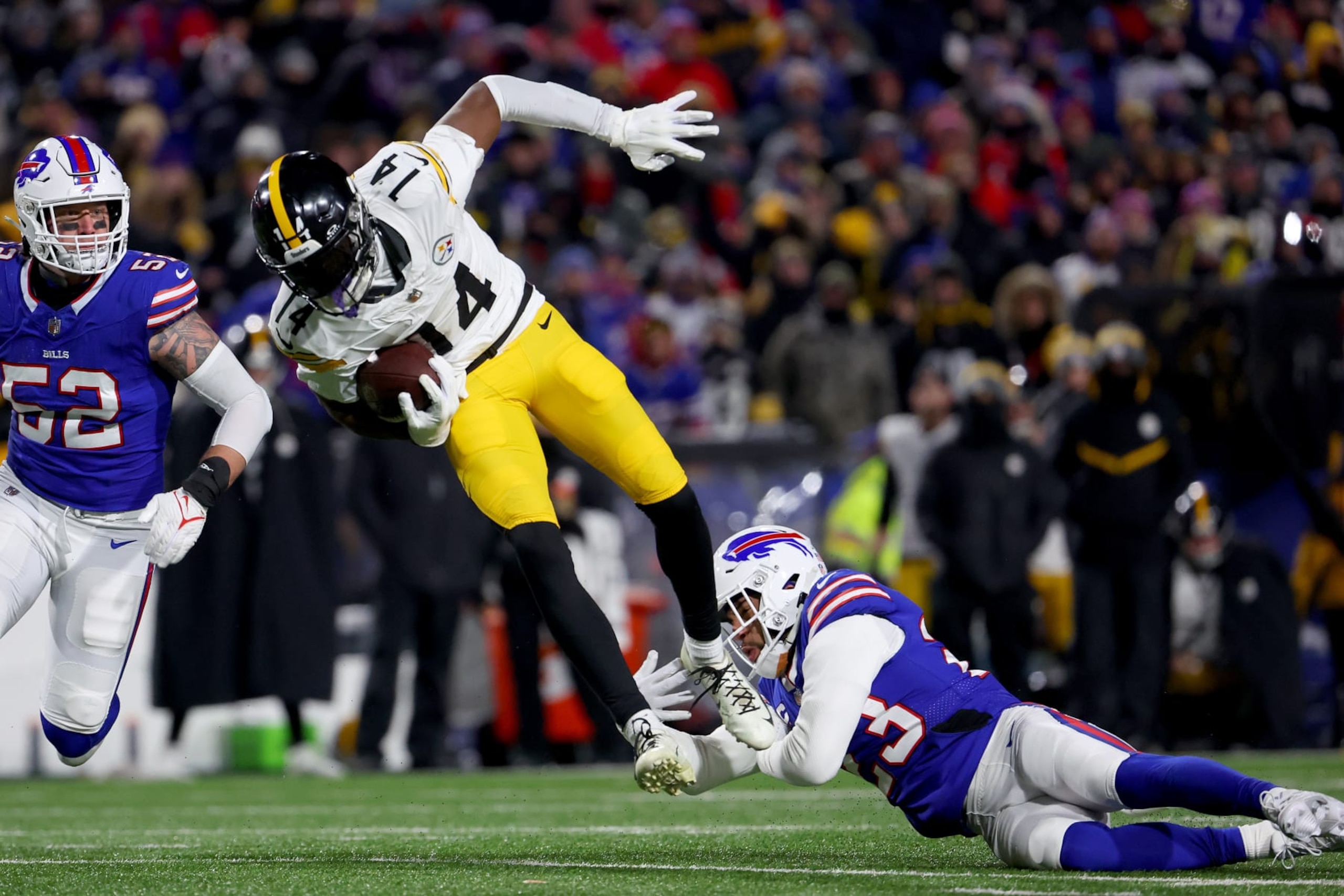 ORCHARD PARK, NEW YORK - JANUARY 15: George Pickens #14 of the Pittsburgh Steelers catches a pass against Micah Hyde #23 of the Buffalo Bills during the third quarter at Highmark Stadium on January 15, 2024 in Orchard Park, New York. (Photo by Timothy T Ludwig/Getty Images)