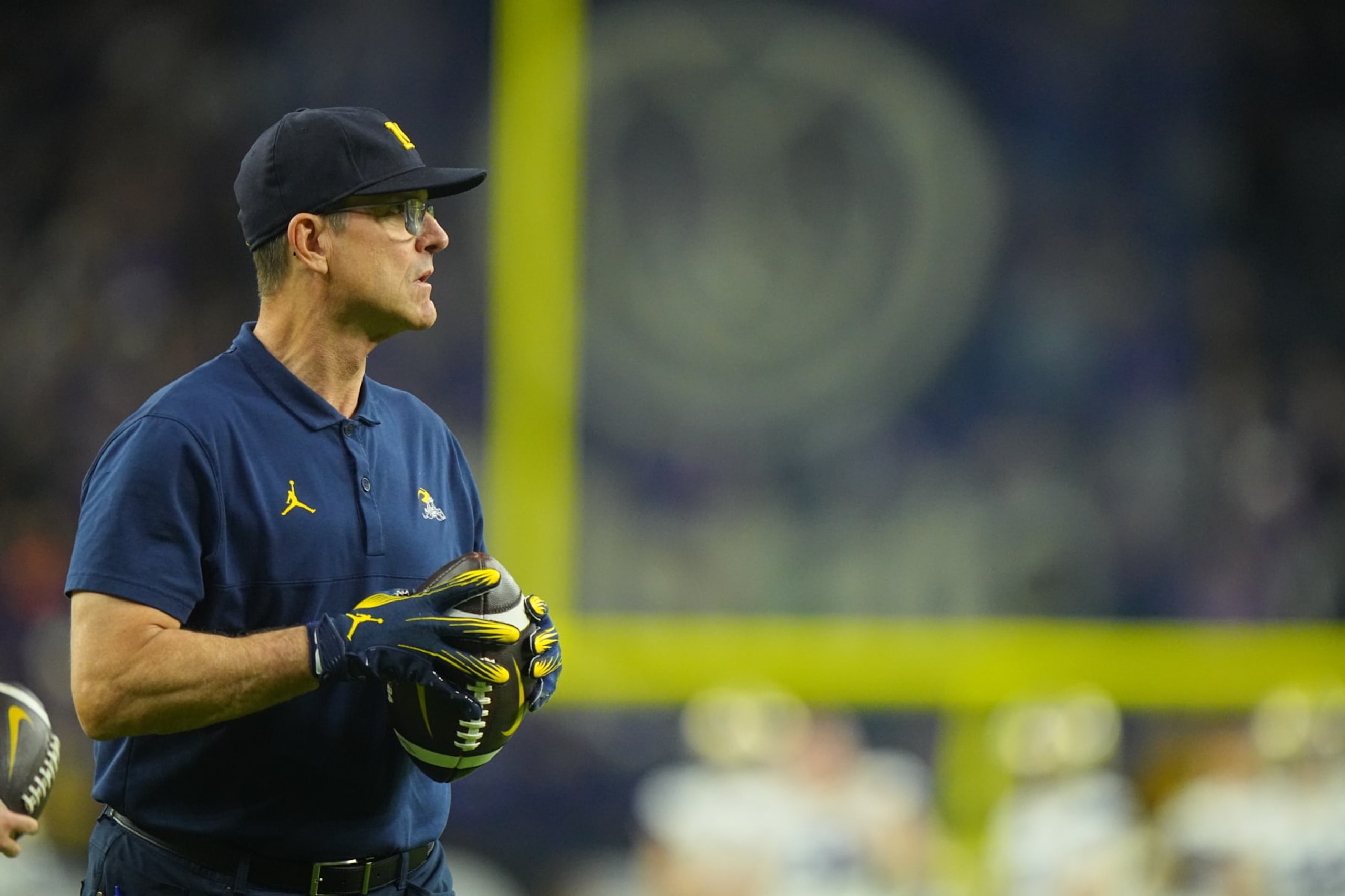 College Football: CFP National Championship: Michigan head coach Jim Harbaugh throws a follow prior to game vs Washington at NRG Stadium. 
Houston, TX 1/8/2024
CREDIT: Erick W. Rasco (Photo by Erick W. Rasco/Sports Illustrated via Getty Images) 
(Set Number: X164476 TK1)