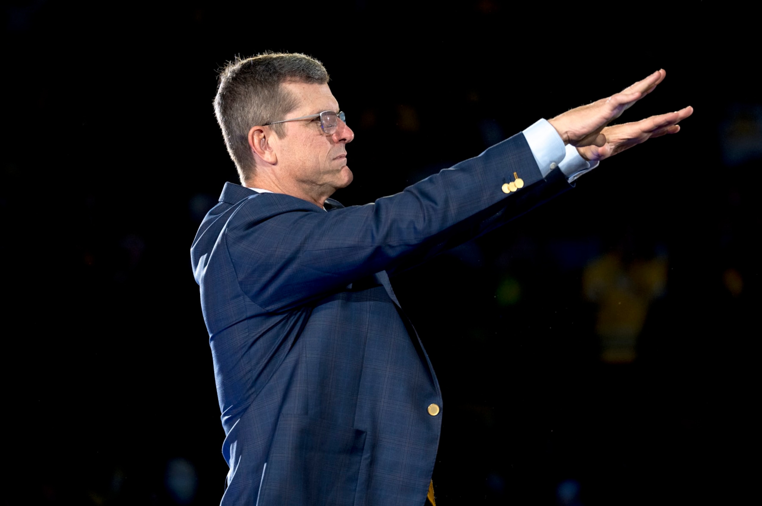 ANN ARBOR, MICHIGAN - JANUARY 13: Head coach Jim Harbaugh of the Michigan Wolverines gestures during the Michigan Wolverines football National Championship celebration on January 13, 2024 at Crisler Center in Ann Arbor, Michigan. (Photo by Nic Antaya/Getty Images)
