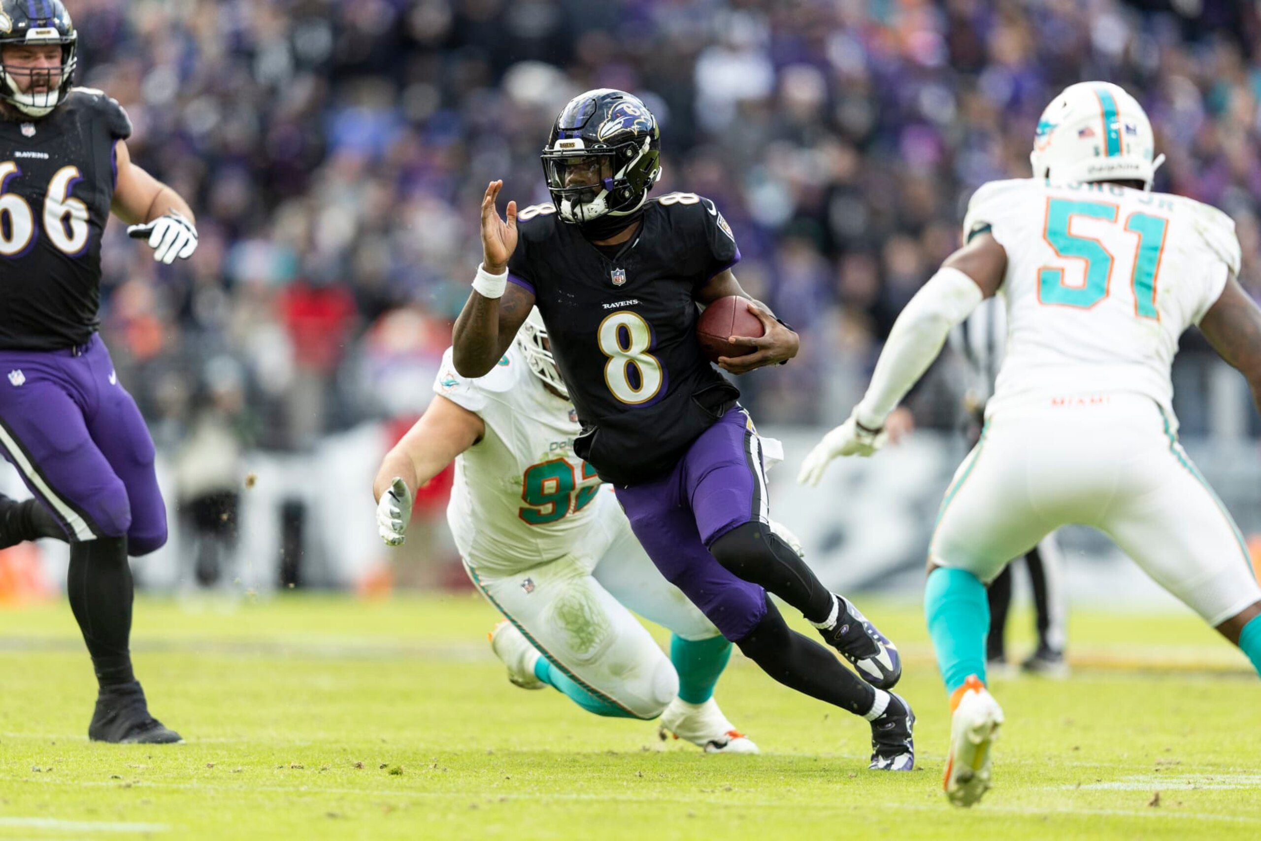 BALTIMORE, MARYLAND - DECEMBER 31: Lamar Jackson #8 of the Baltimore Ravens scrambles and runs with the ball during an NFL football game between the Baltimore Ravens and the Miami Dolphins at M&T Bank Stadium on December 31, 2023 in Baltimore, Maryland. (Photo by Michael Owens/Getty Images) BALTIMORE, MARYLAND - DECEMBER 31: Lamar Jackson #8 of the Baltimore Ravens scrambles and runs with the ball during an NFL football game between the Baltimore Ravens and the Miami Dolphins at M&T Bank Stadium on December 31, 2023 in Baltimore, Maryland. (Photo by Michael Owens/Getty Images)