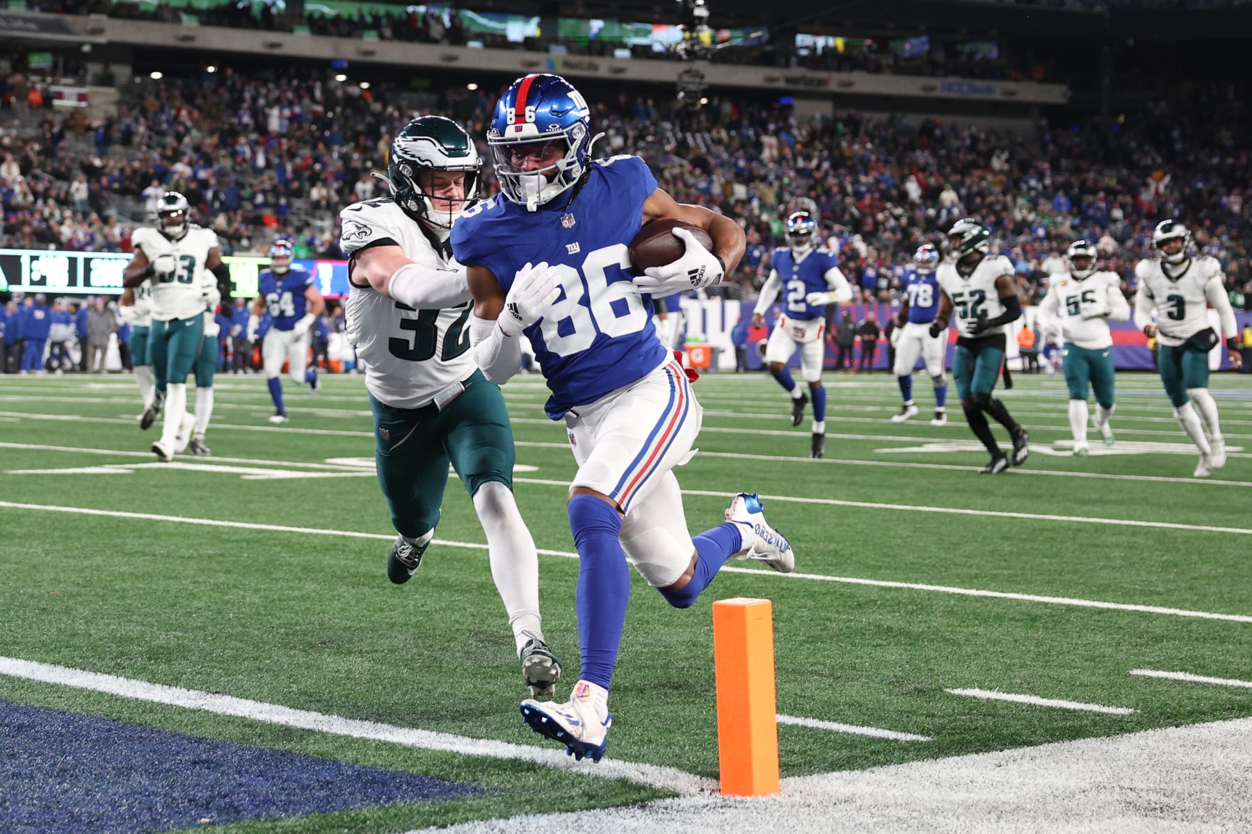 EAST RUTHERFORD, NEW JERSEY - JANUARY 07: Darius Slayton #86 of the New York Giants scores a touchdown while defended by Reed Blankenship #32 of the Philadelphia Eagles during the second quarter at MetLife Stadium on January 07, 2024 in East Rutherford, New Jersey. (Photo by Elsa/Getty Images)