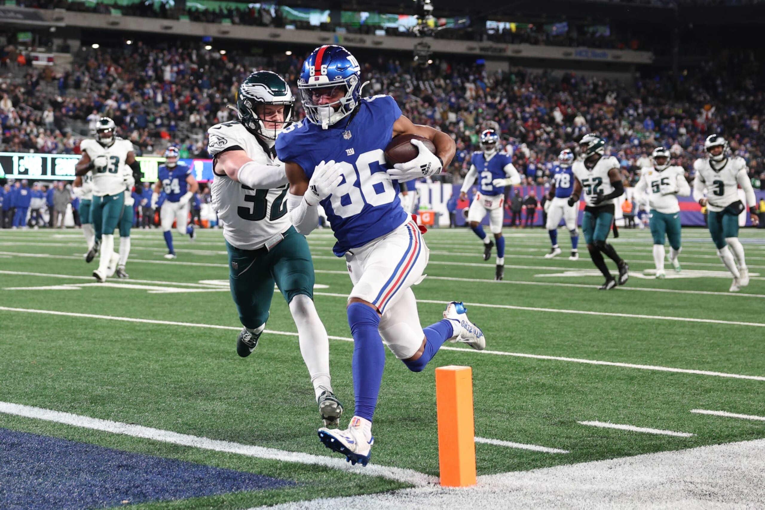 EAST RUTHERFORD, NEW JERSEY - JANUARY 07: Darius Slayton #86 of the New York Giants scores a touchdown while defended by Reed Blankenship #32 of the Philadelphia Eagles during the second quarter at MetLife Stadium on January 07, 2024 in East Rutherford, New Jersey. (Photo by Elsa/Getty Images)