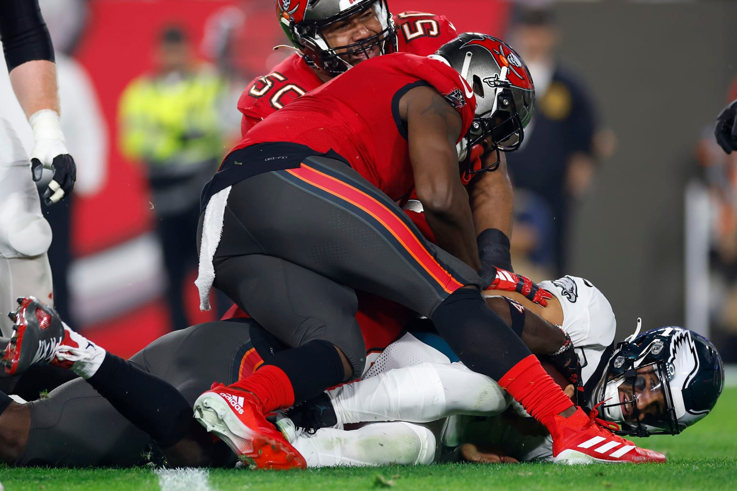 TAMPA, FLORIDA - JANUARY 15: Calijah Kancey #94 of the Tampa Bay Buccaneers sacks Jalen Hurts #1 of the Philadelphia Eagles during the third quarter in the NFC Wild Card Playoffs at Raymond James Stadium on January 15, 2024 in Tampa, Florida. (Photo by Mike Ehrmann/Getty Images)