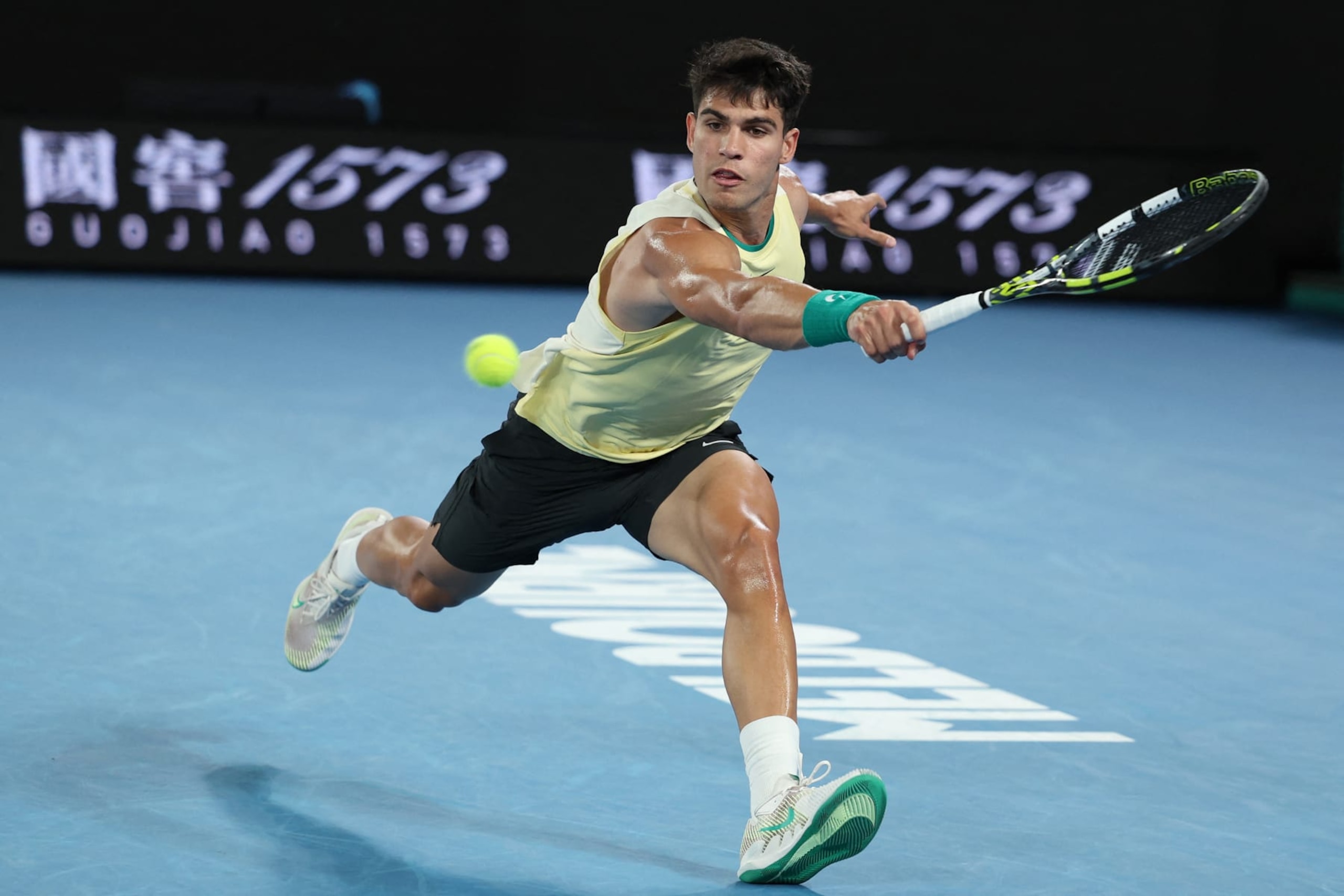 Spain's Carlos Alcaraz hits a return against France's Richard Gasquet during their men's singles match on day three of the Australian Open tennis tournament in Melbourne on January 16, 2024. (Photo by Martin KEEP / AFP) / -- IMAGE RESTRICTED TO EDITORIAL USE - STRICTLY NO COMMERCIAL USE -- (Photo by MARTIN KEEP/AFP via Getty Images) Spain's Carlos Alcaraz hits a return against France's Richard Gasquet during their men's singles match on day three of the Australian Open tennis tournament in Melbourne on January 16, 2024. (Photo by Martin KEEP / AFP) / -- IMAGE RESTRICTED TO EDITORIAL USE - STRICTLY NO COMMERCIAL USE -- (Photo by MARTIN KEEP/AFP via Getty Images)