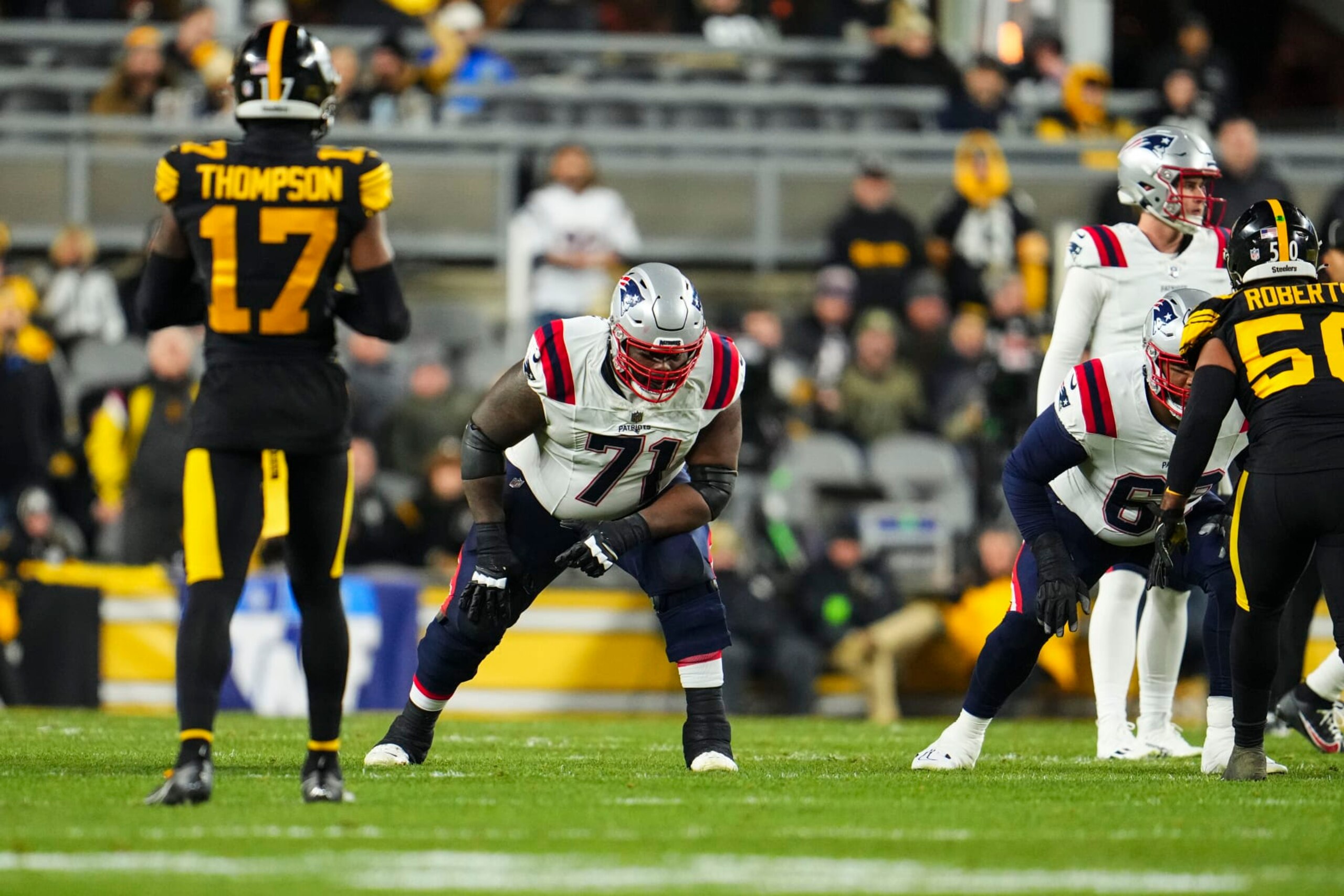 PITTSBURGH, PA - DECEMBER 07: Mike Onwenu #71 of the New England Patriots lines up during an NFL football game against the Pittsburgh Steelers at Acrisure Stadium on December 7, 2023 in Pittsburgh, Pennsylvania. (Photo by Cooper Neill/Getty Images)