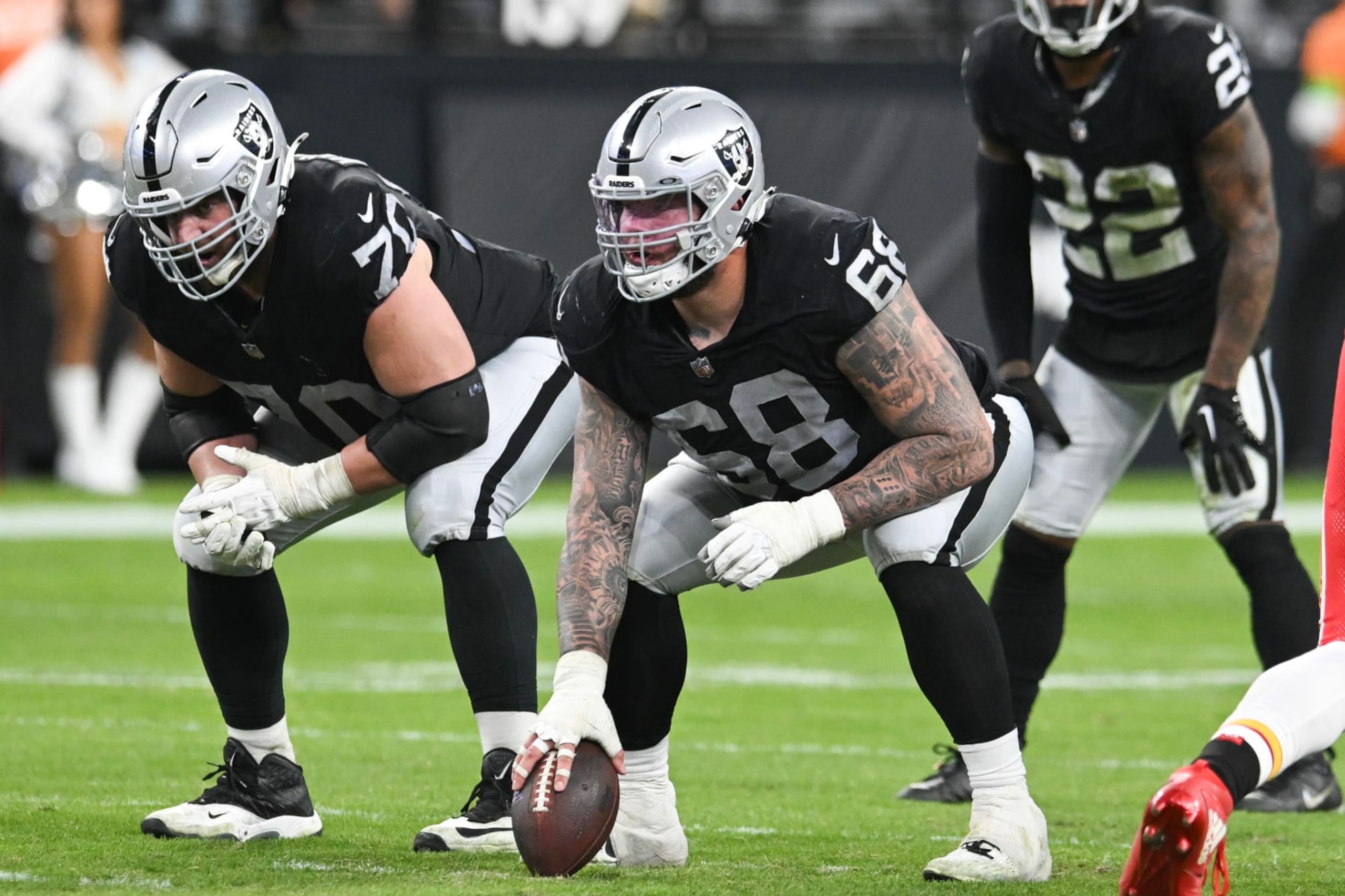 LAS VEGAS, NEVADA - NOVEMBER 26: Guard Greg Van Roten #70 and center Andre James #68 of the Las Vegas Raiders line up before the snap against the Kansas City Chiefs in the fourth quarter at Allegiant Stadium on November 26, 2023 in Las Vegas, Nevada. The Chiefs defeated the Raiders 31-17. (Photo by Candice Ward/Getty Images)