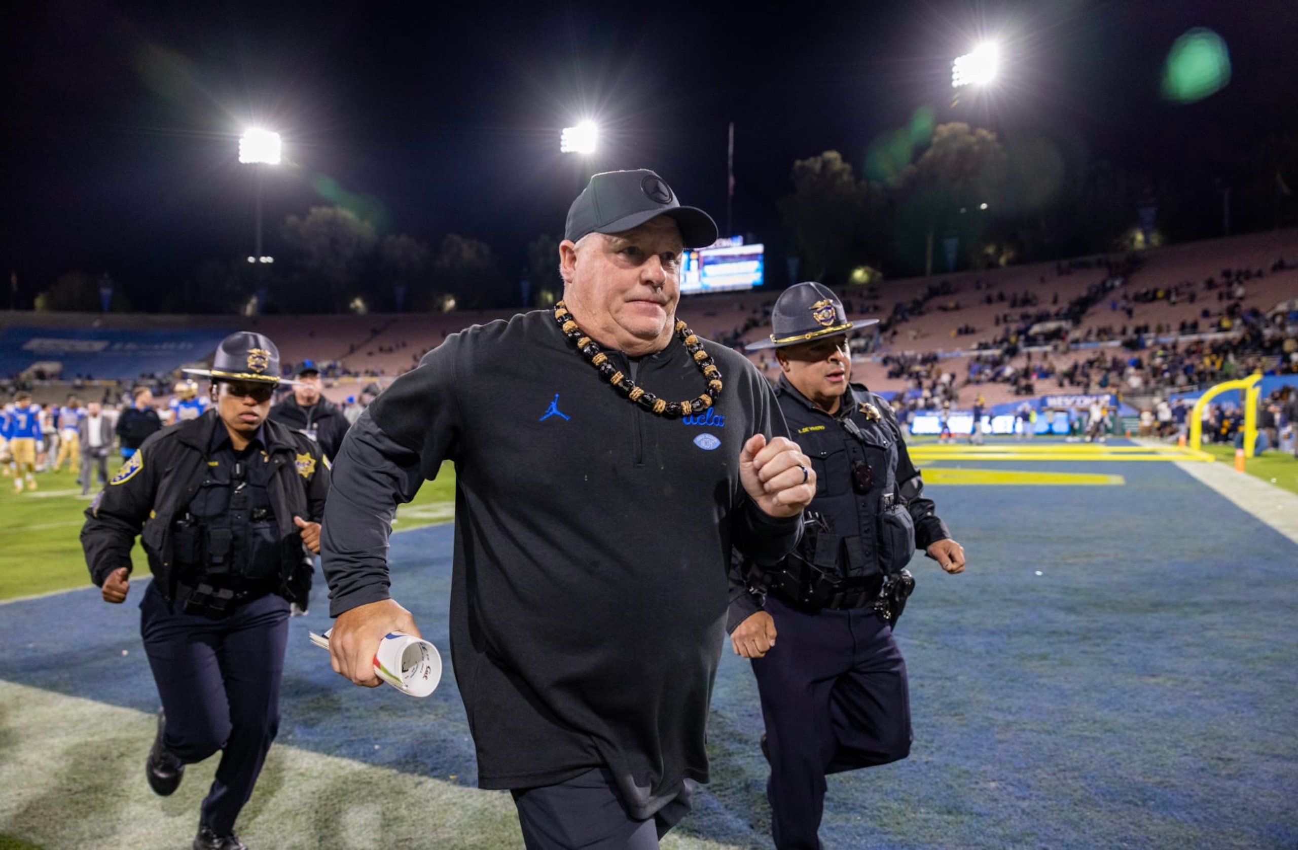 PASADENA, CA  - NOVEMBER 25, 2023: UCLA Bruins head coach Chip Kelly runs off the field after his team's 33-7 loss to California  at the Rose Bowl on November 25, 2023 in Pasadena, California.(Gina Ferazzi / Los Angeles Times via Getty Images)