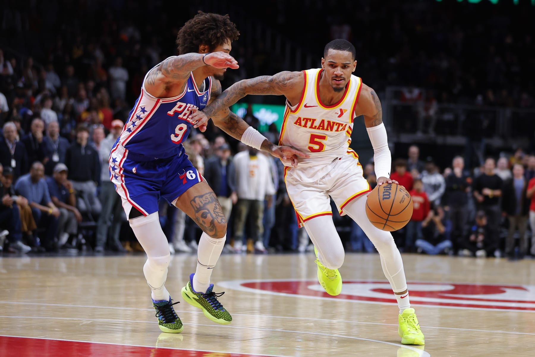 ATLANTA, GEORGIA - JANUARY 10: Dejounte Murray #5 of the Atlanta Hawks charges into the paint against Kelly Oubre Jr. #9 of the Philadelphia 76ers in overtime at State Farm Arena on January 10, 2024 in Atlanta, Georgia. NOTE TO USER: User expressly acknowledges and agrees that, by downloading and or using this photograph, User is consenting to the terms and conditions of the Getty Images License Agreement. (Photo by Todd Kirkland/Getty Images)