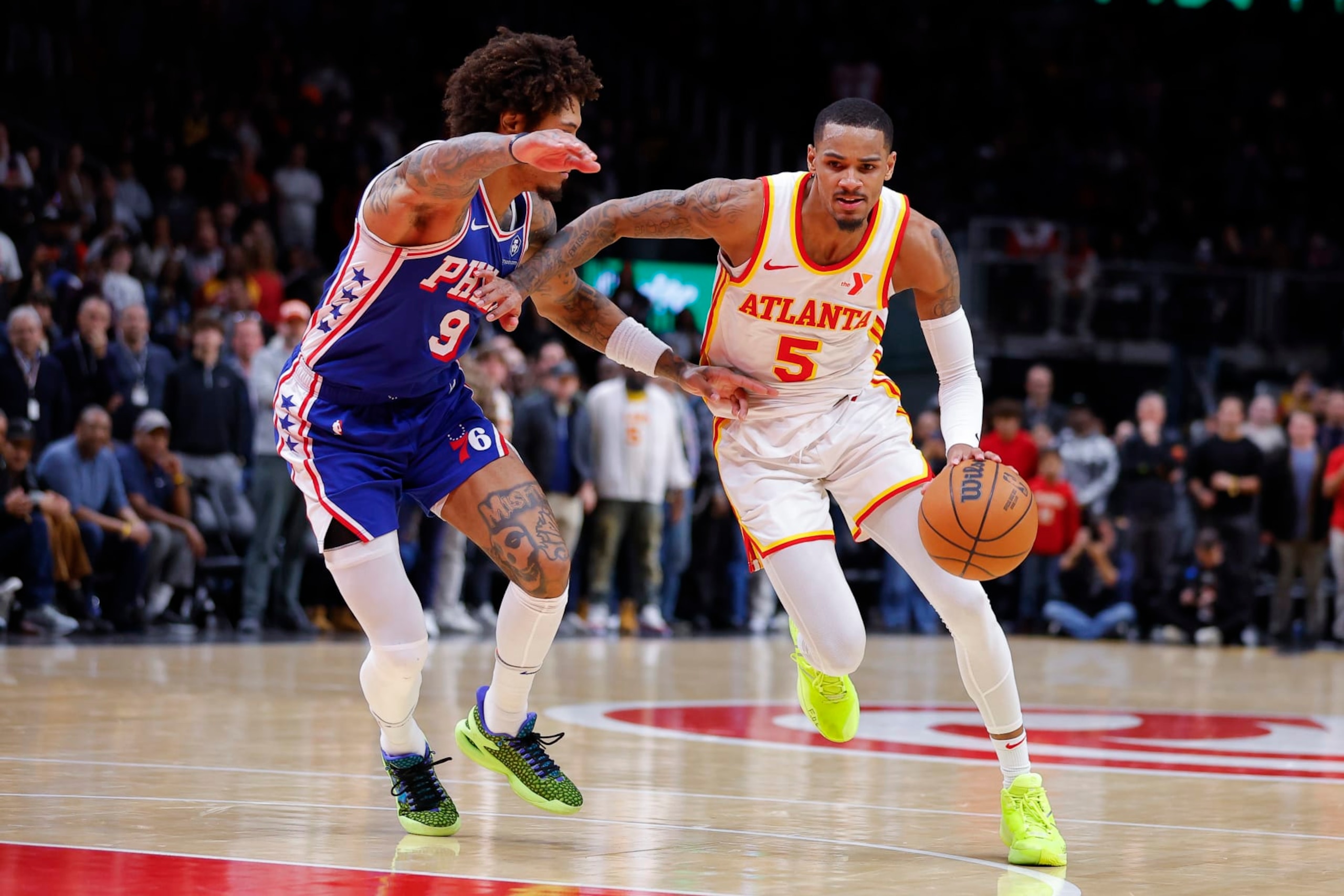ATLANTA, GEORGIA - JANUARY 10: Dejounte Murray #5 of the Atlanta Hawks charges into the paint against Kelly Oubre Jr. #9 of the Philadelphia 76ers in overtime at State Farm Arena on January 10, 2024 in Atlanta, Georgia. NOTE TO USER: User expressly acknowledges and agrees that, by downloading and or using this photograph, User is consenting to the terms and conditions of the Getty Images License Agreement. (Photo by Todd Kirkland/Getty Images)