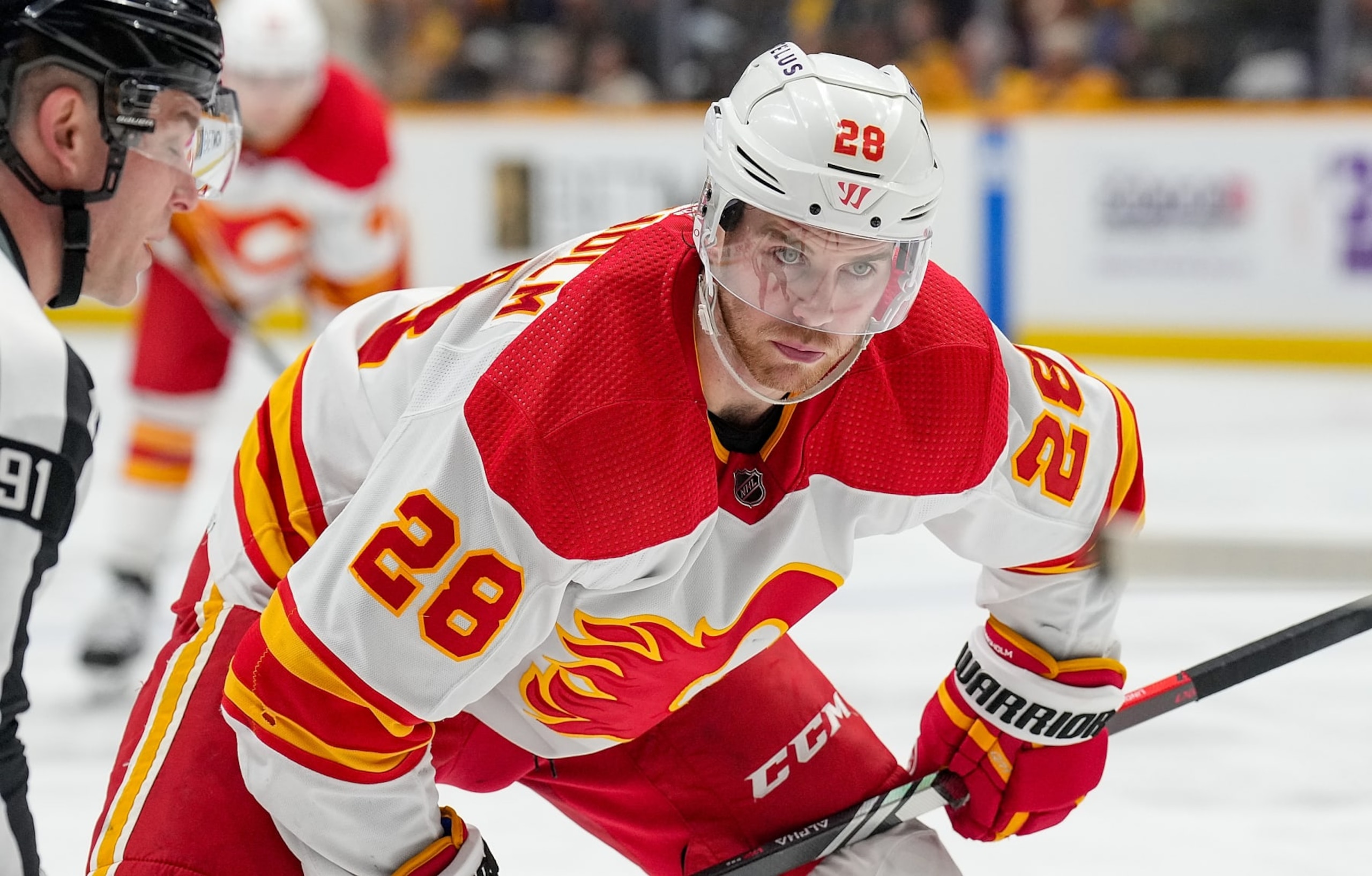 NASHVILLE, TENNESSEE - JANUARY 4: Elias Lindholm #28 of the Calgary Flames faces off against the Nashville Predators during an NHL game at Bridgestone Arena on January 4, 2024 in Nashville, Tennessee. (Photo by John Russell/NHLI via Getty Images)
